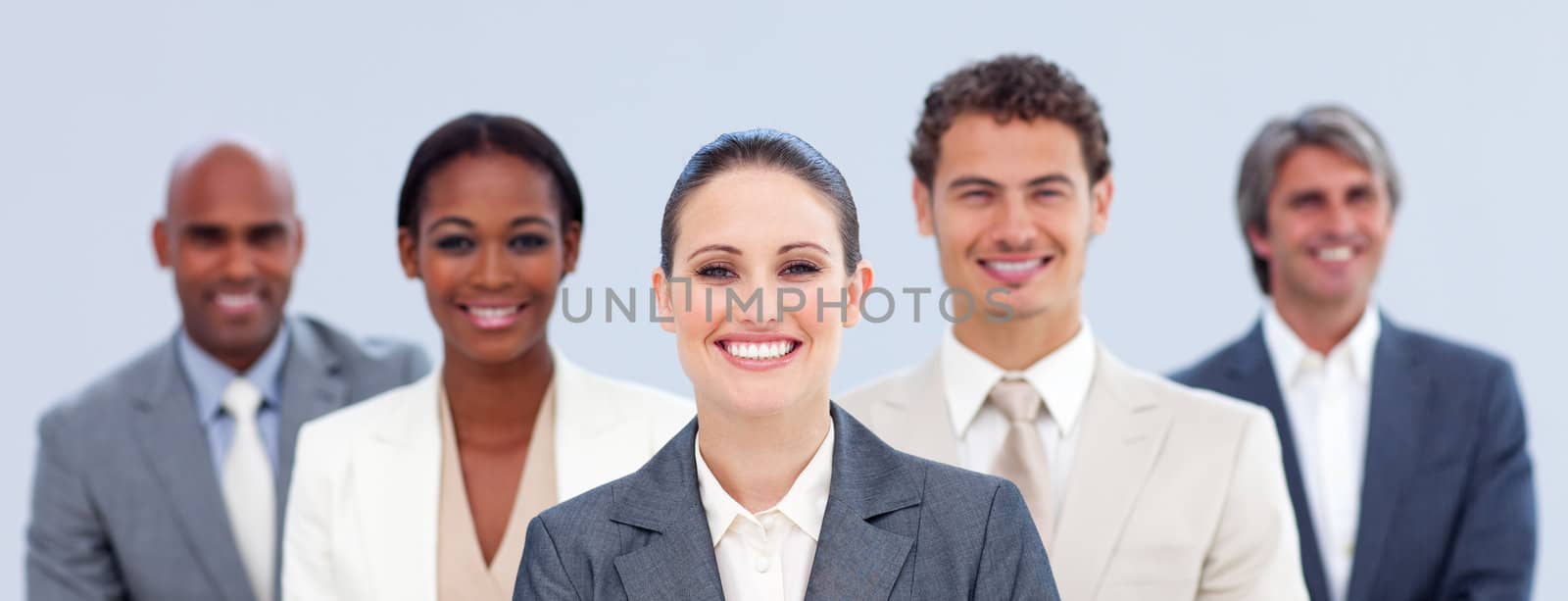 Multi-ethnic business team standing looking at the camera