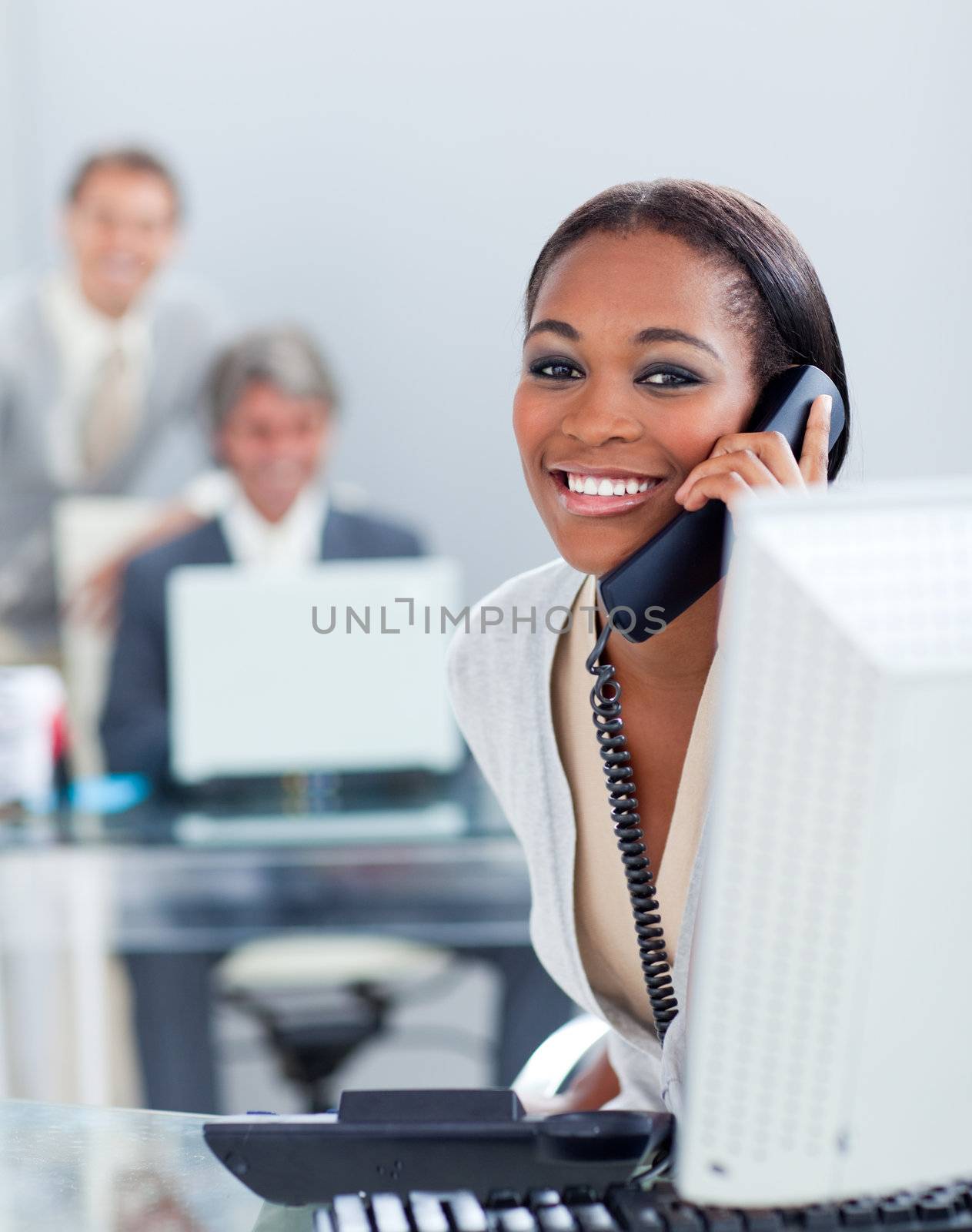 Beautiful businesswoman on phone at her desk in the office