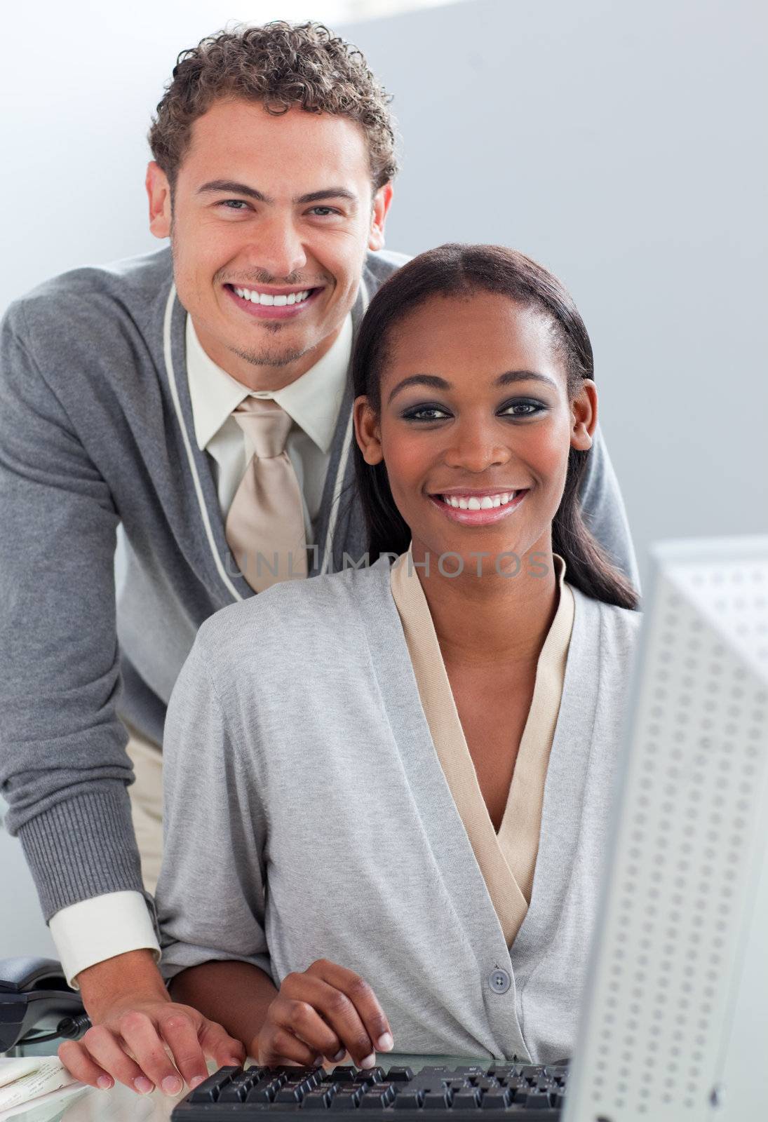 Multi-ethnic business partners working at a computer in the office