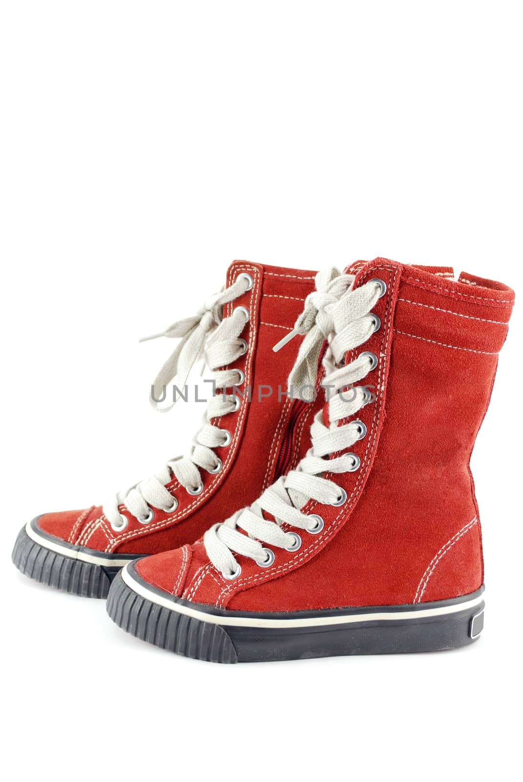 Child red sneakers on white