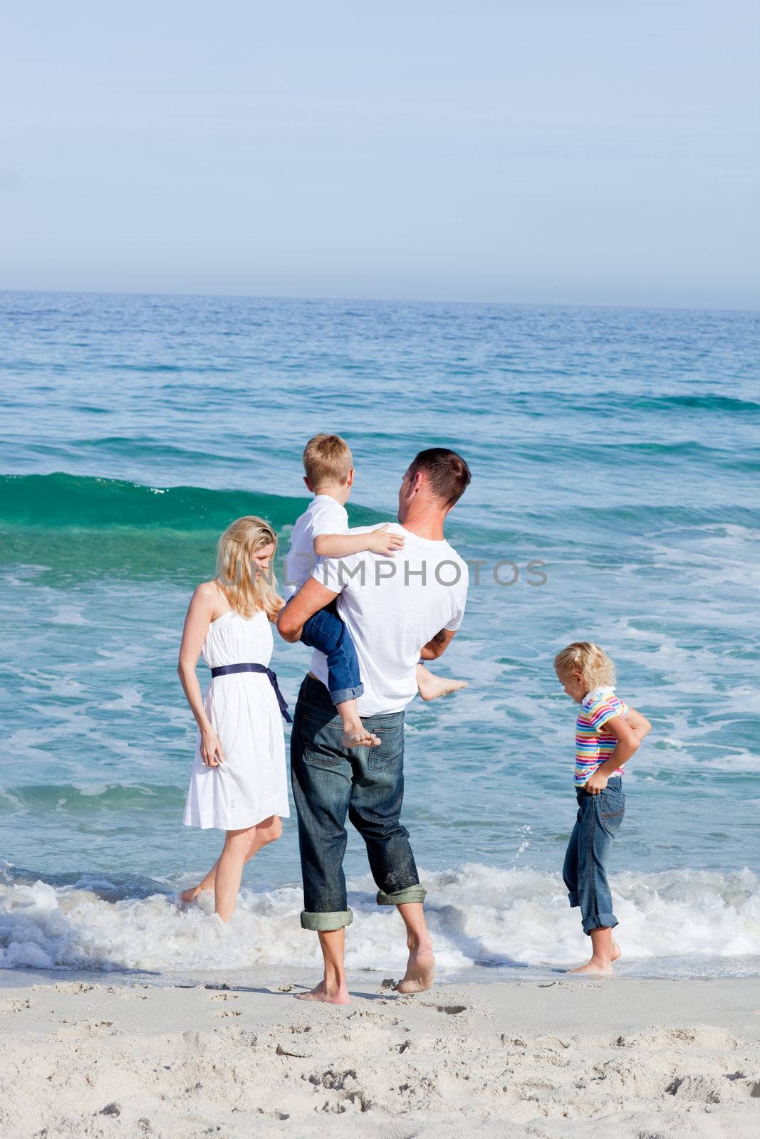 Affectionate family having fun at the beach by Wavebreakmedia