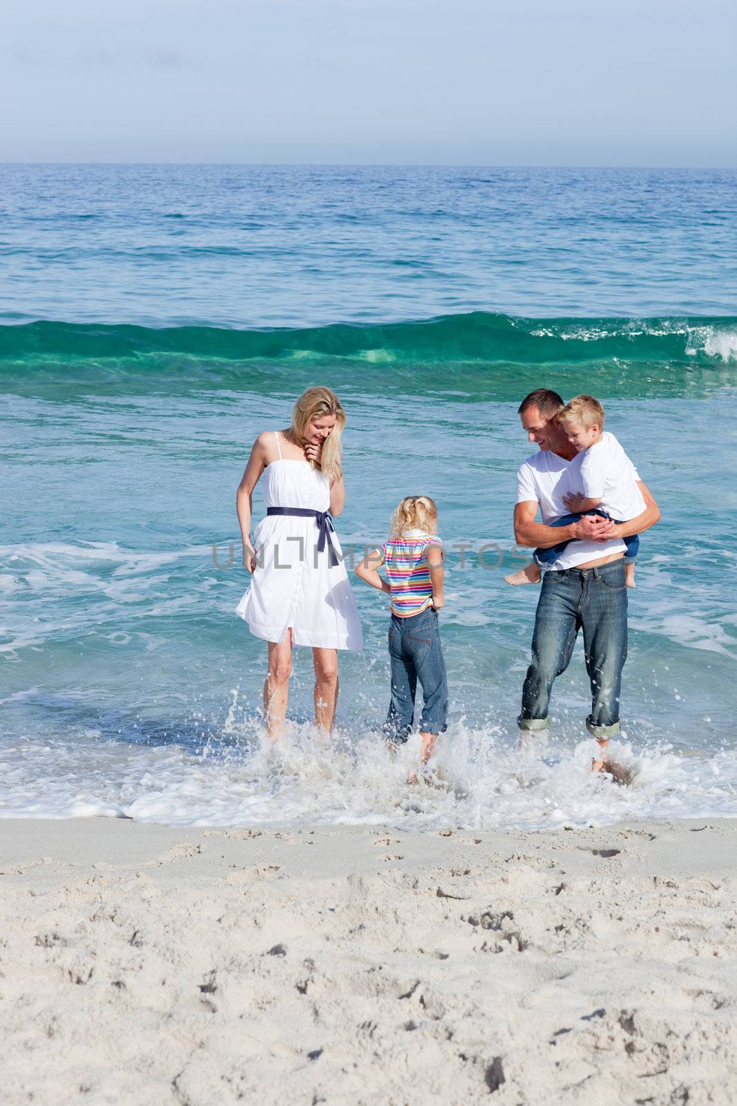 Cheerful family having fun at the beach by Wavebreakmedia