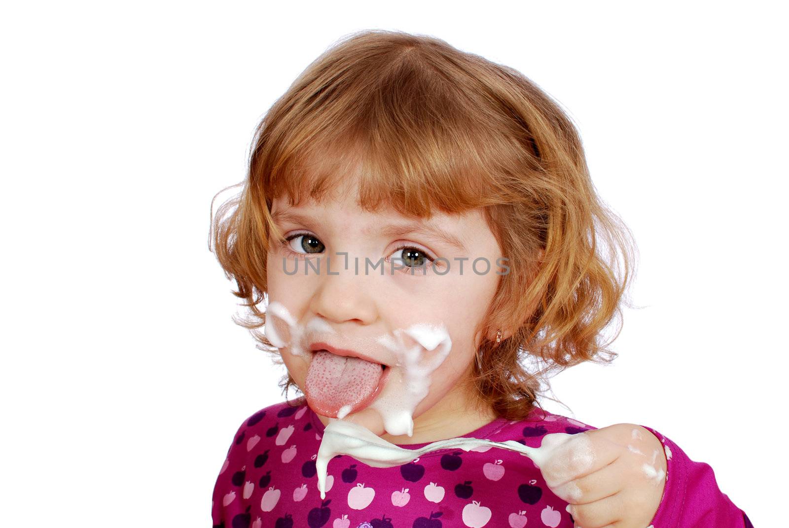 Little girl eating sweet cream studio shot