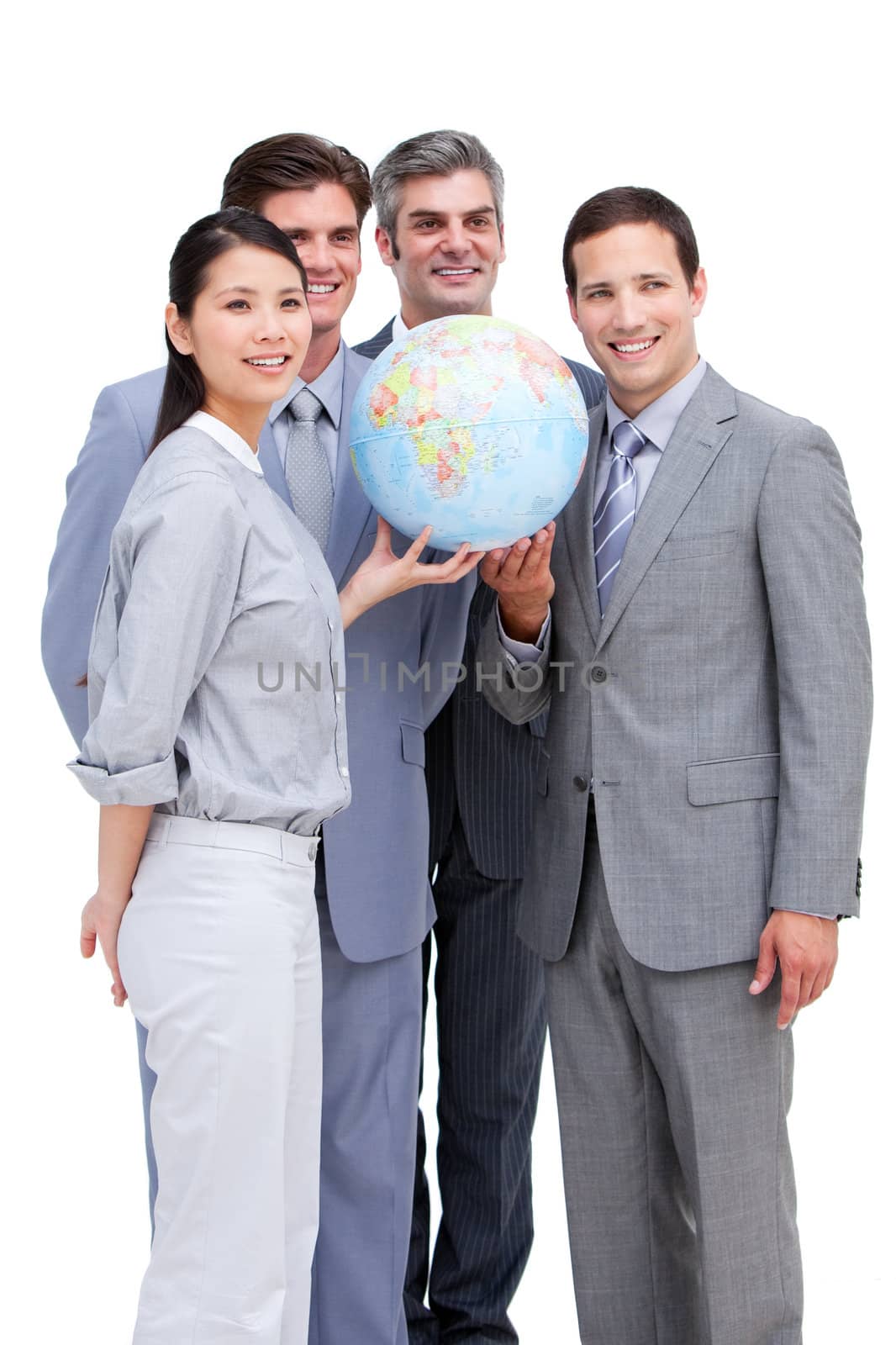 Successful businessteam looking at a terrestrial globe against a white background