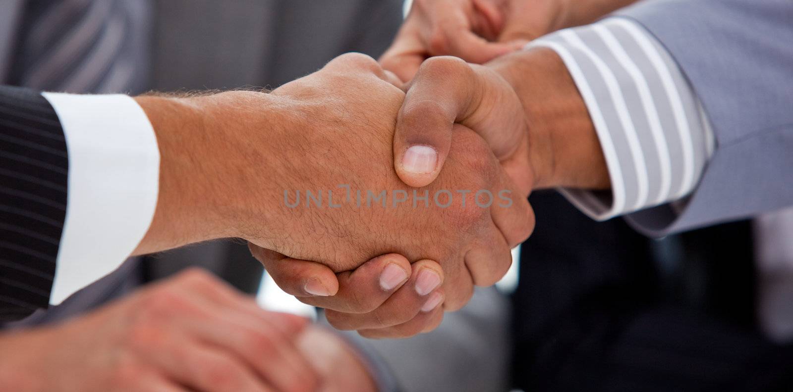 Close-up of two businessmen closing a deal in a meeting