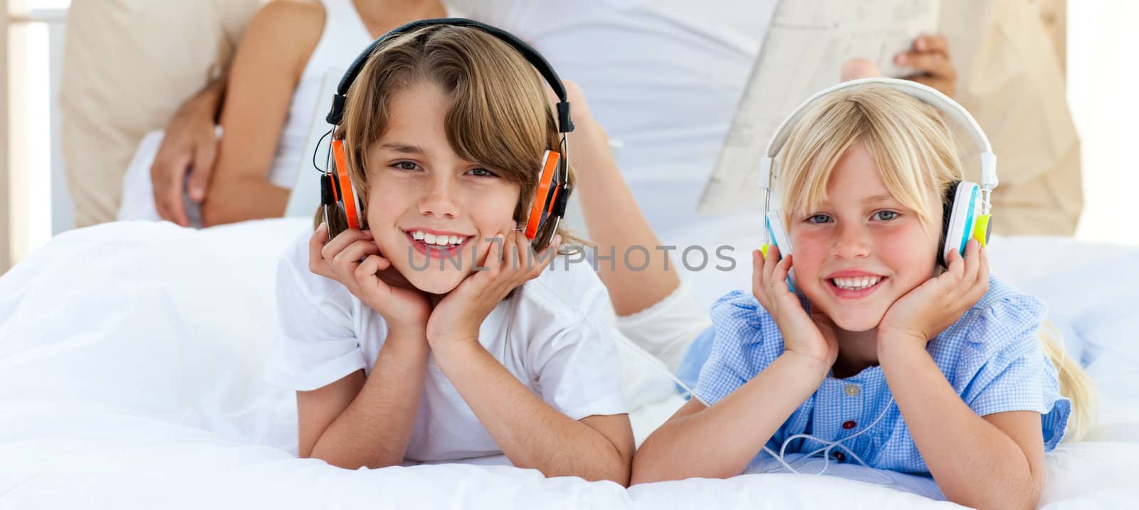 Close-up of siblings listening music with headphones