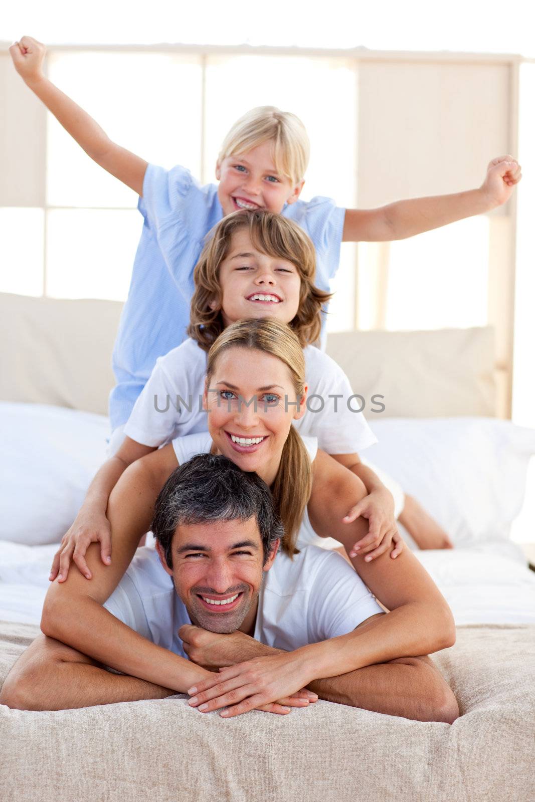 Loving family having fun in the bedroom 