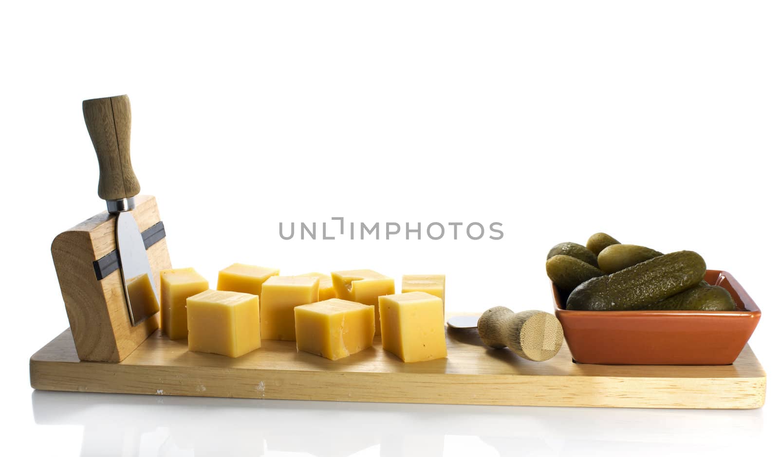 dutch cheese and pickle on wooden plate