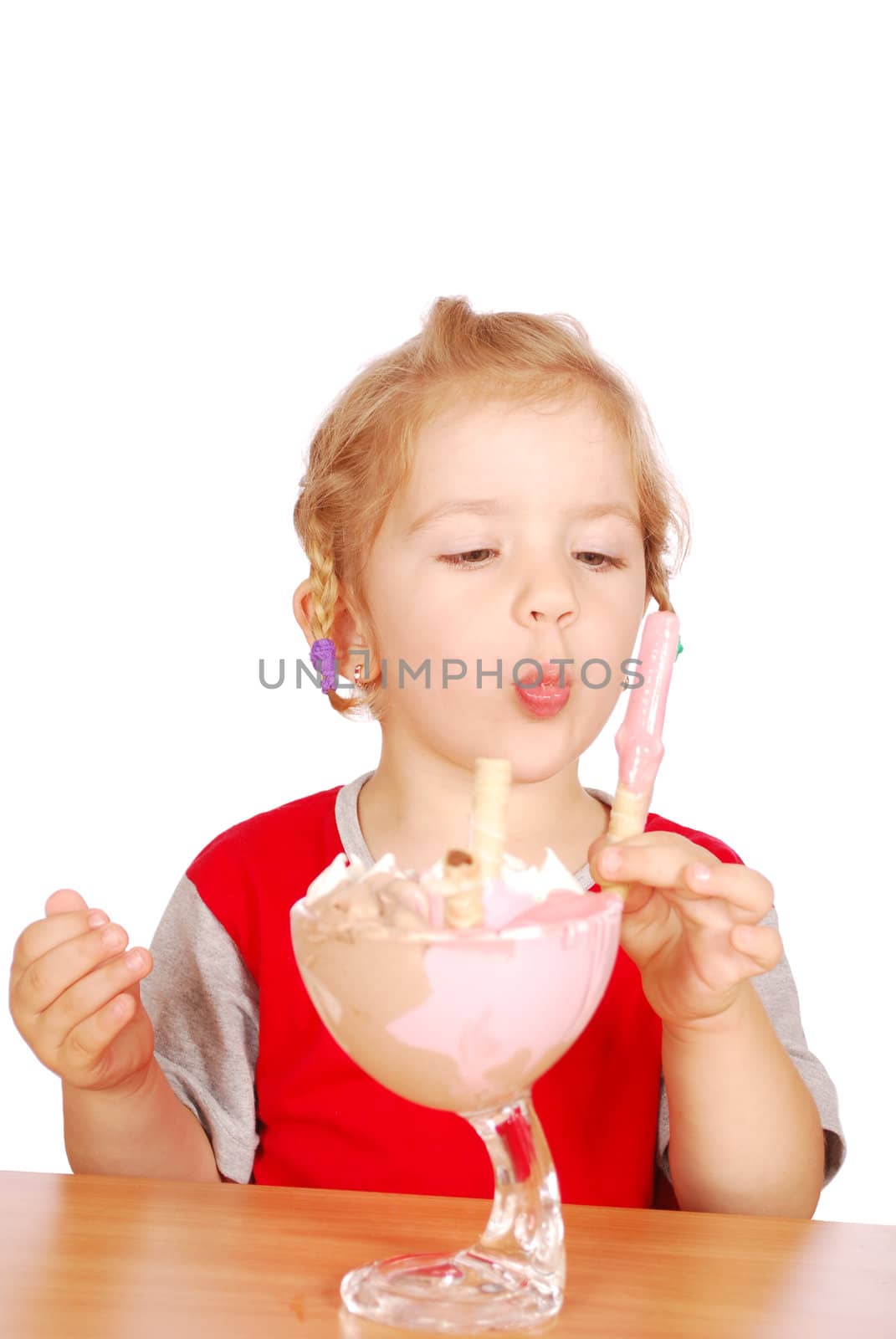 Little girl eating ice cream studio shot