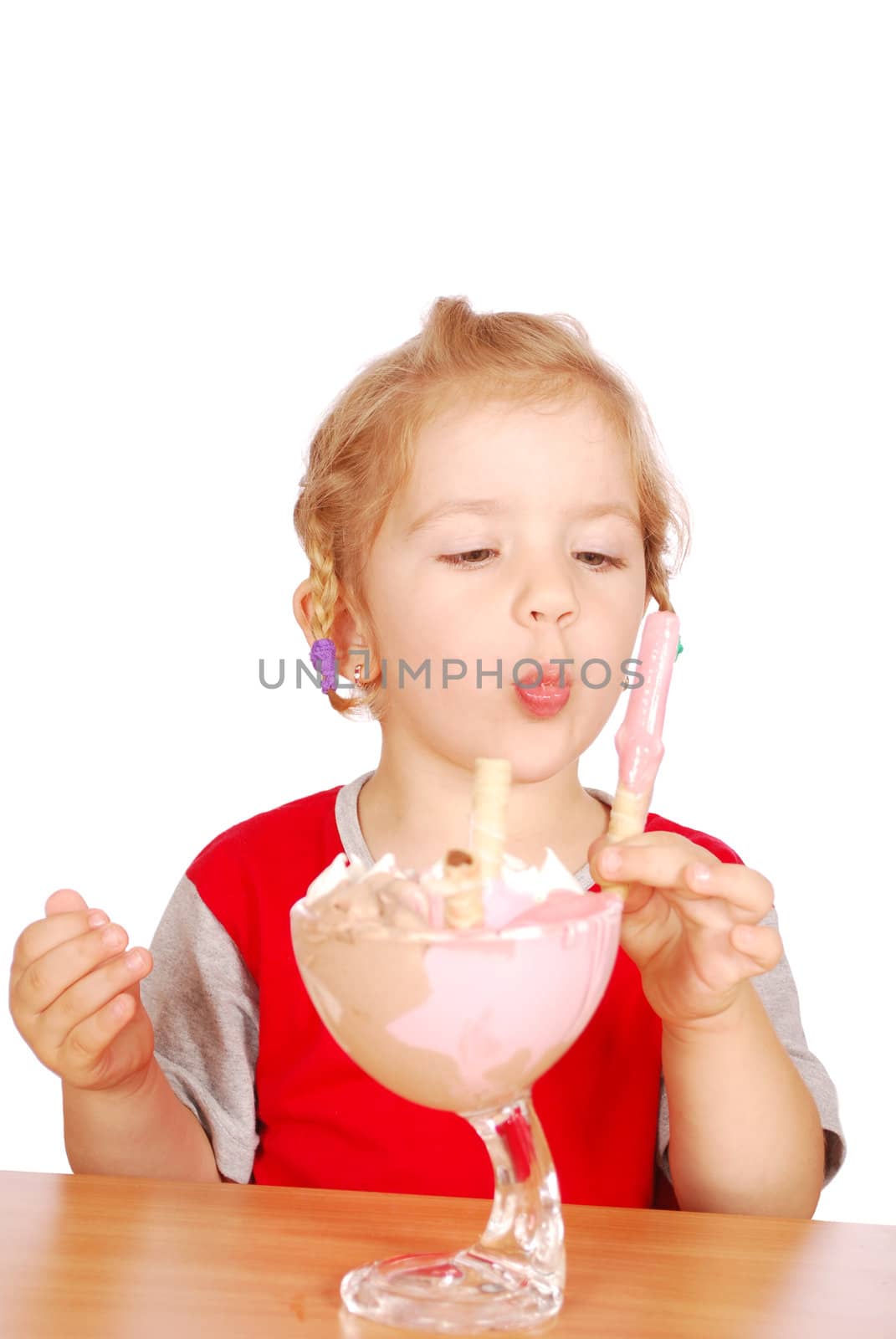 Little girl eating ice cream studio shot