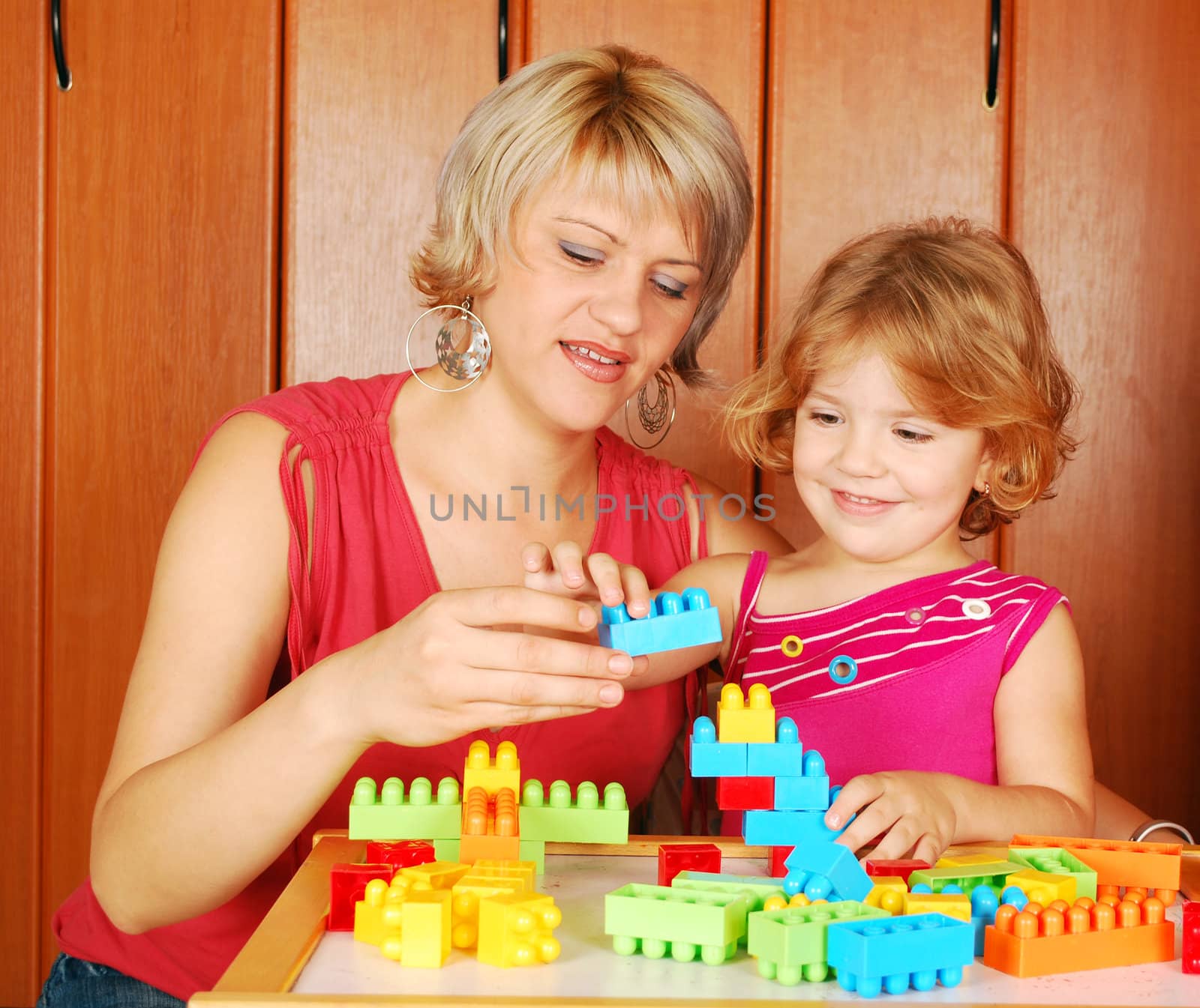 Mother and daughter playing with toy blocks