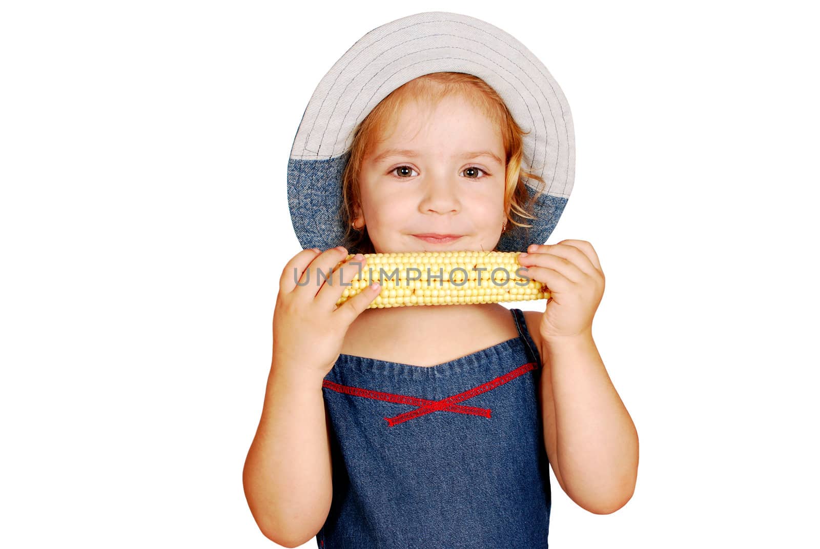 Little girl eating corn studio shot