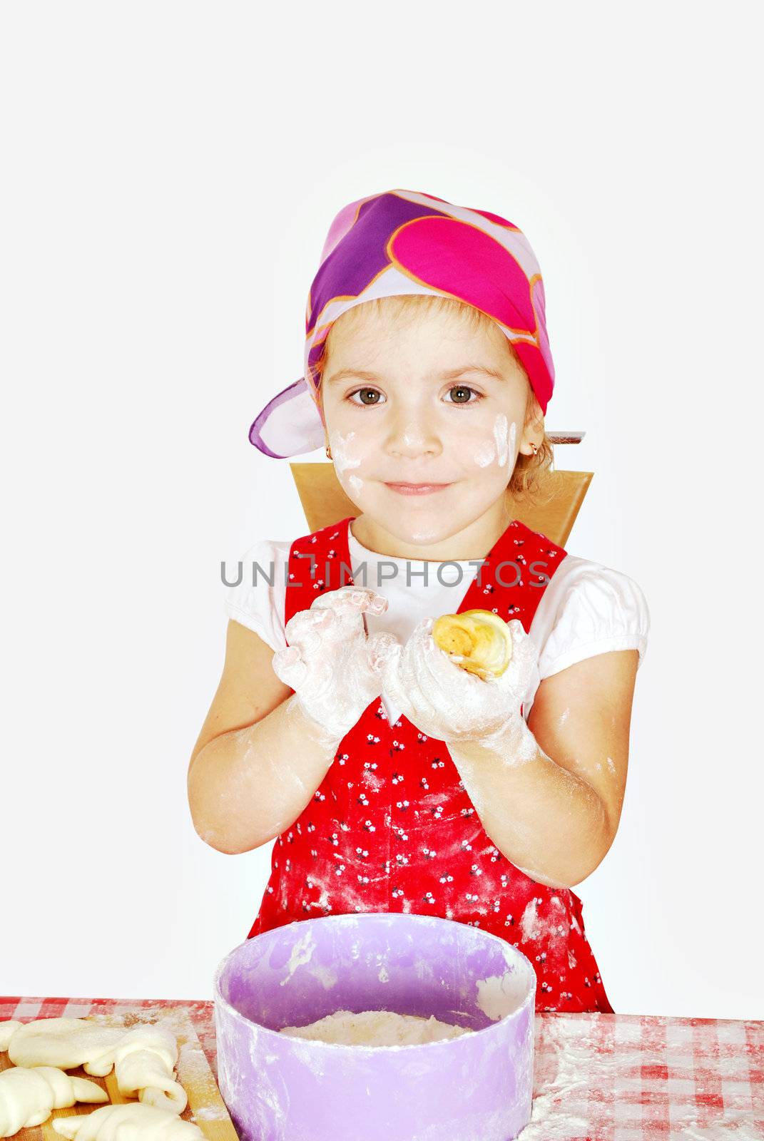 Little girl make croissant studio shot