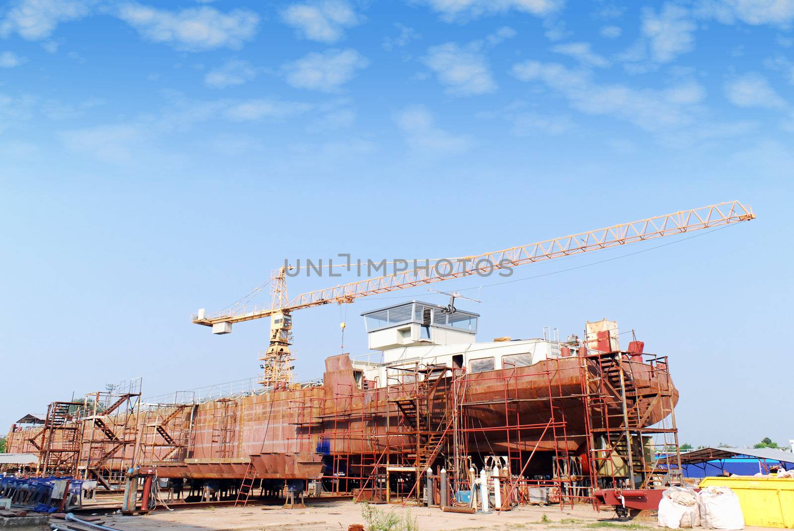 Heavy industry shipyard with crane and tanker