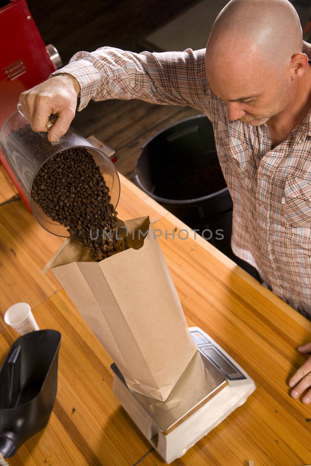 An experienced coffee roaster bags up his finished product.