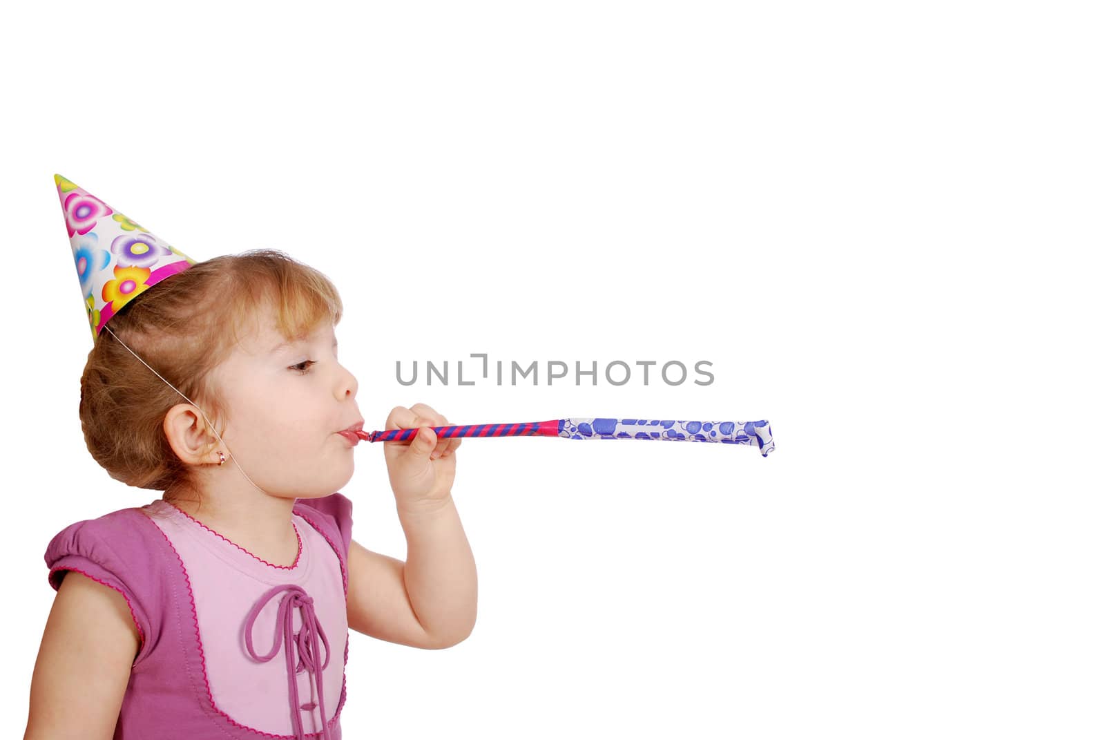 Little girl with birthday hat and trumpet studio shot