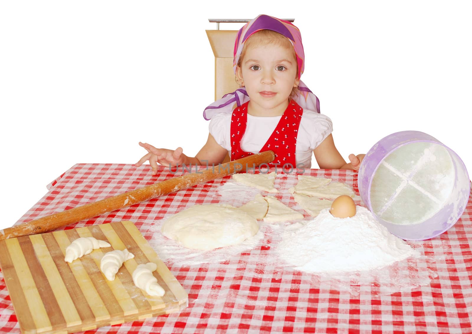 Little girl with flour and rolls studio shot
