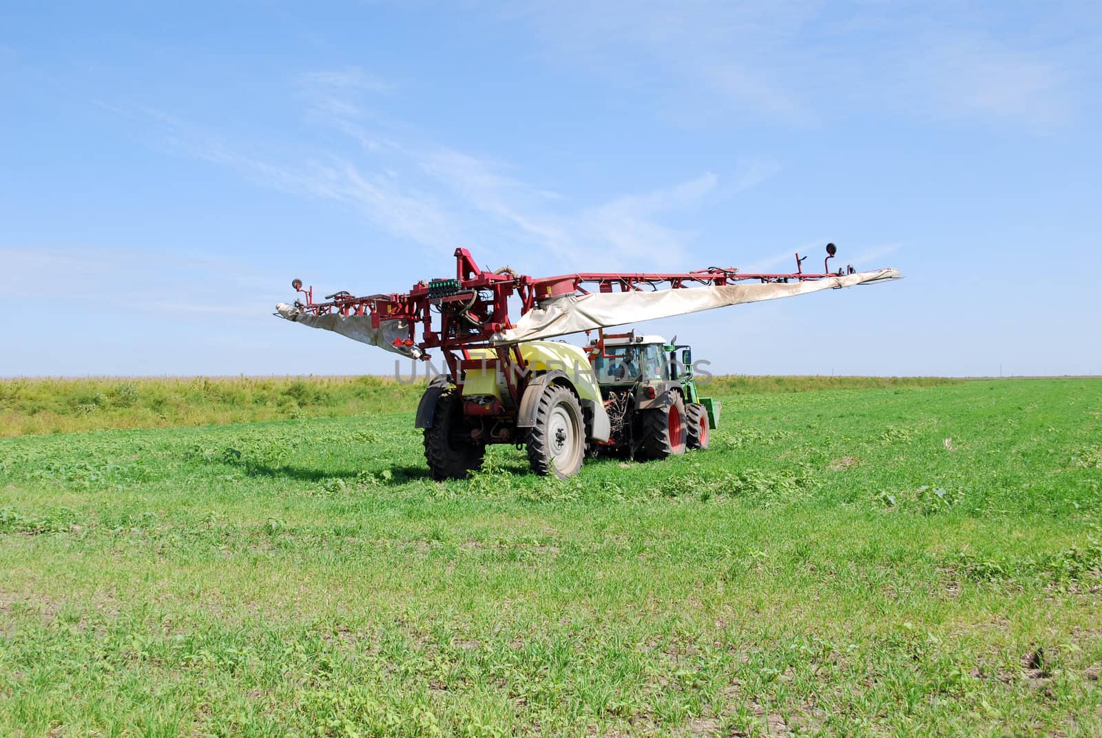 Tractor with sprayer preparing for work
