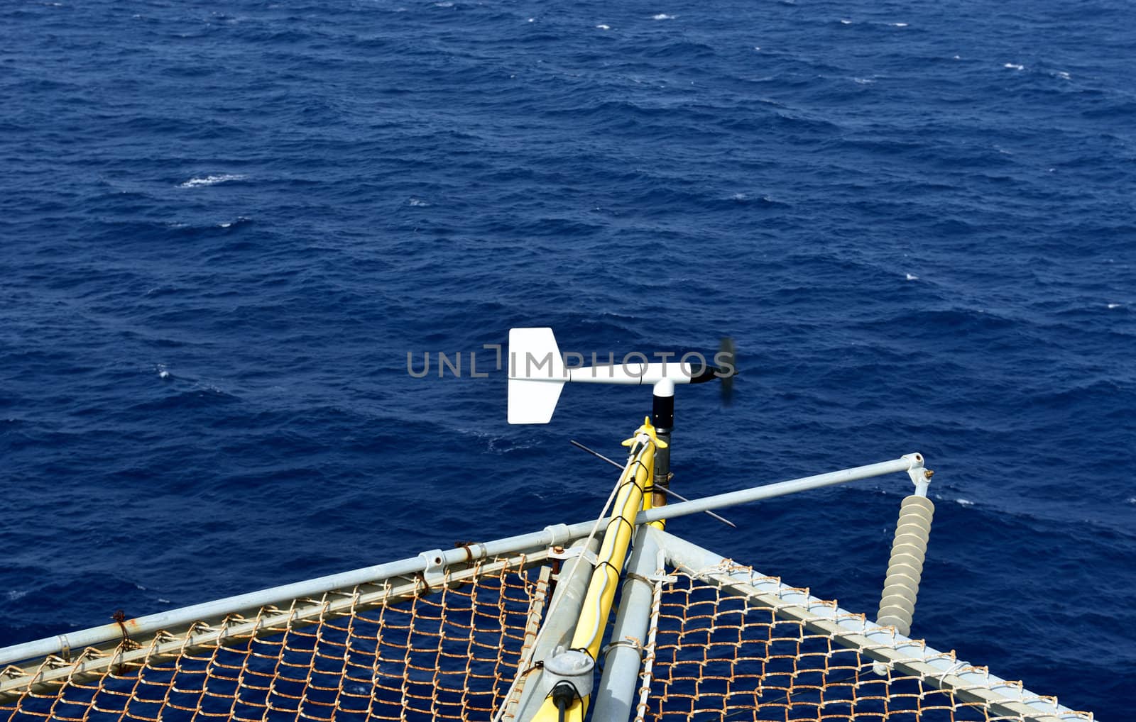 The wind velocity and direction indicator is set on the corner of oil rig helideck .