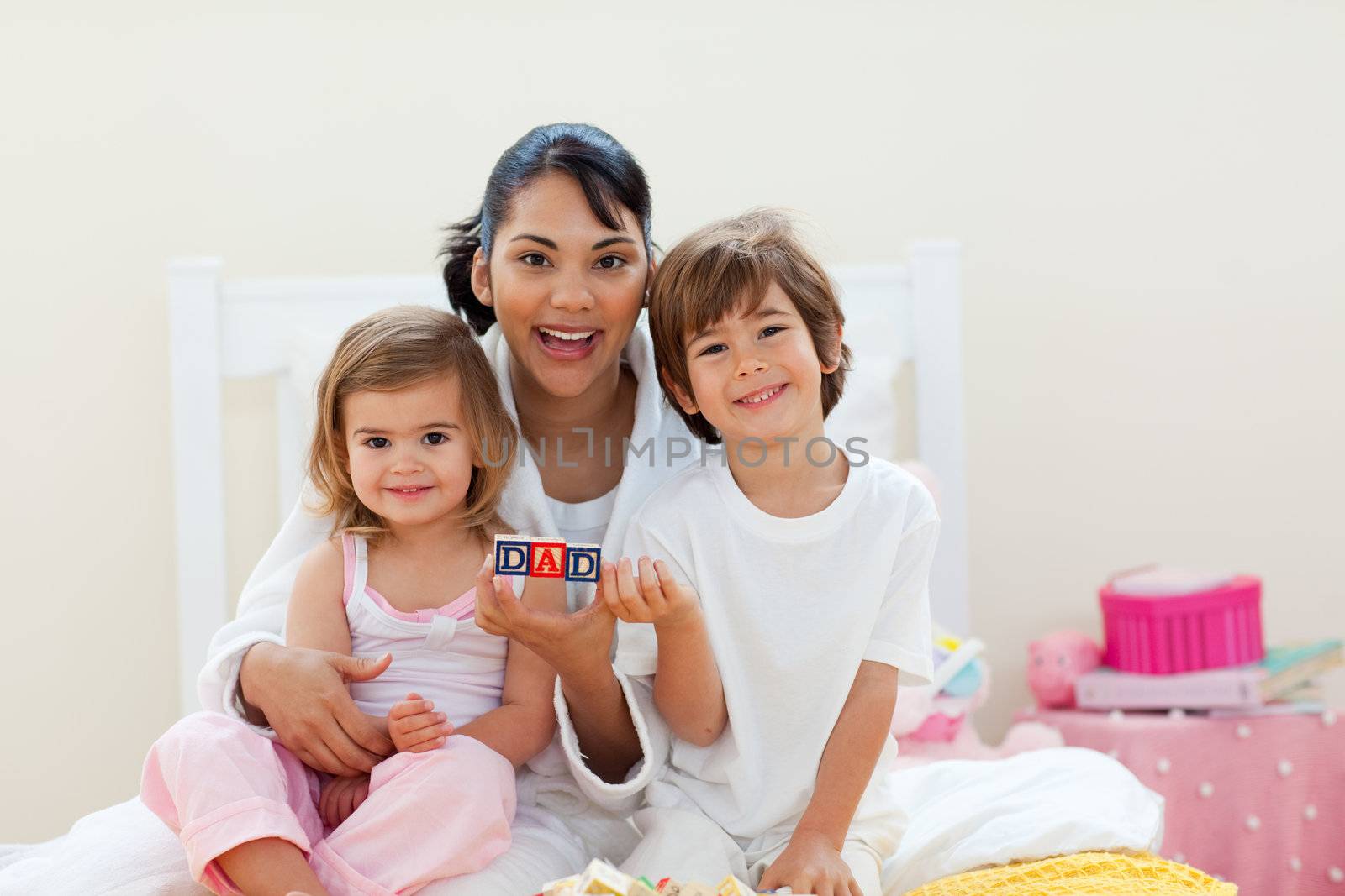 Attractive mother and her children playing with letters blocks by Wavebreakmedia