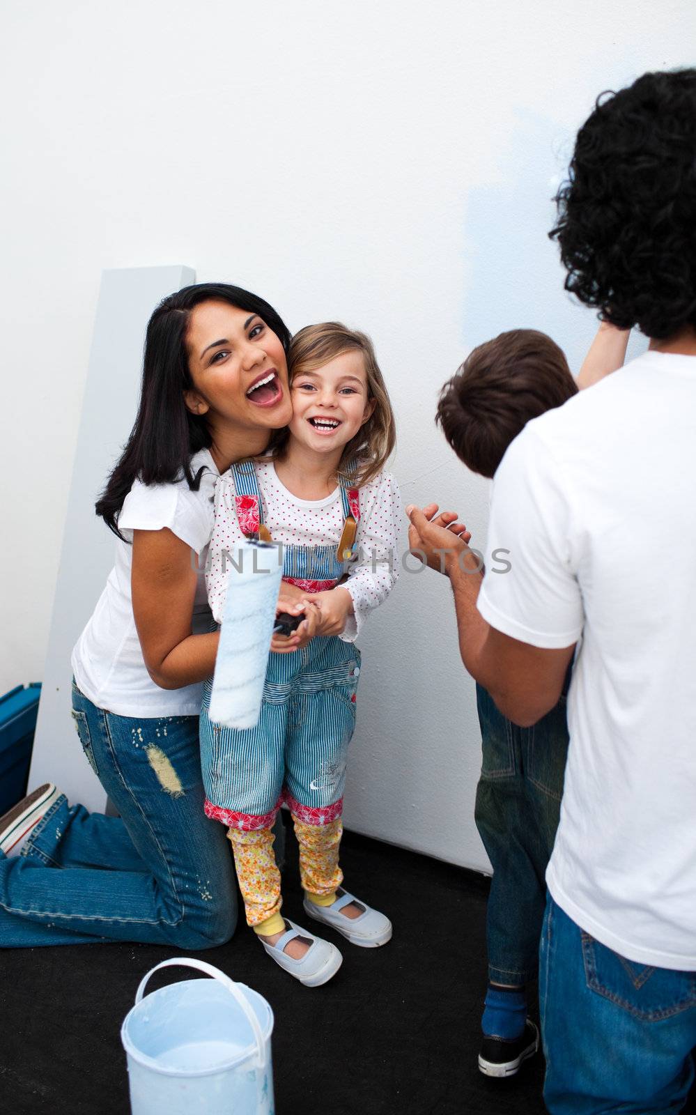 Happy parents with their children painting a room  by Wavebreakmedia