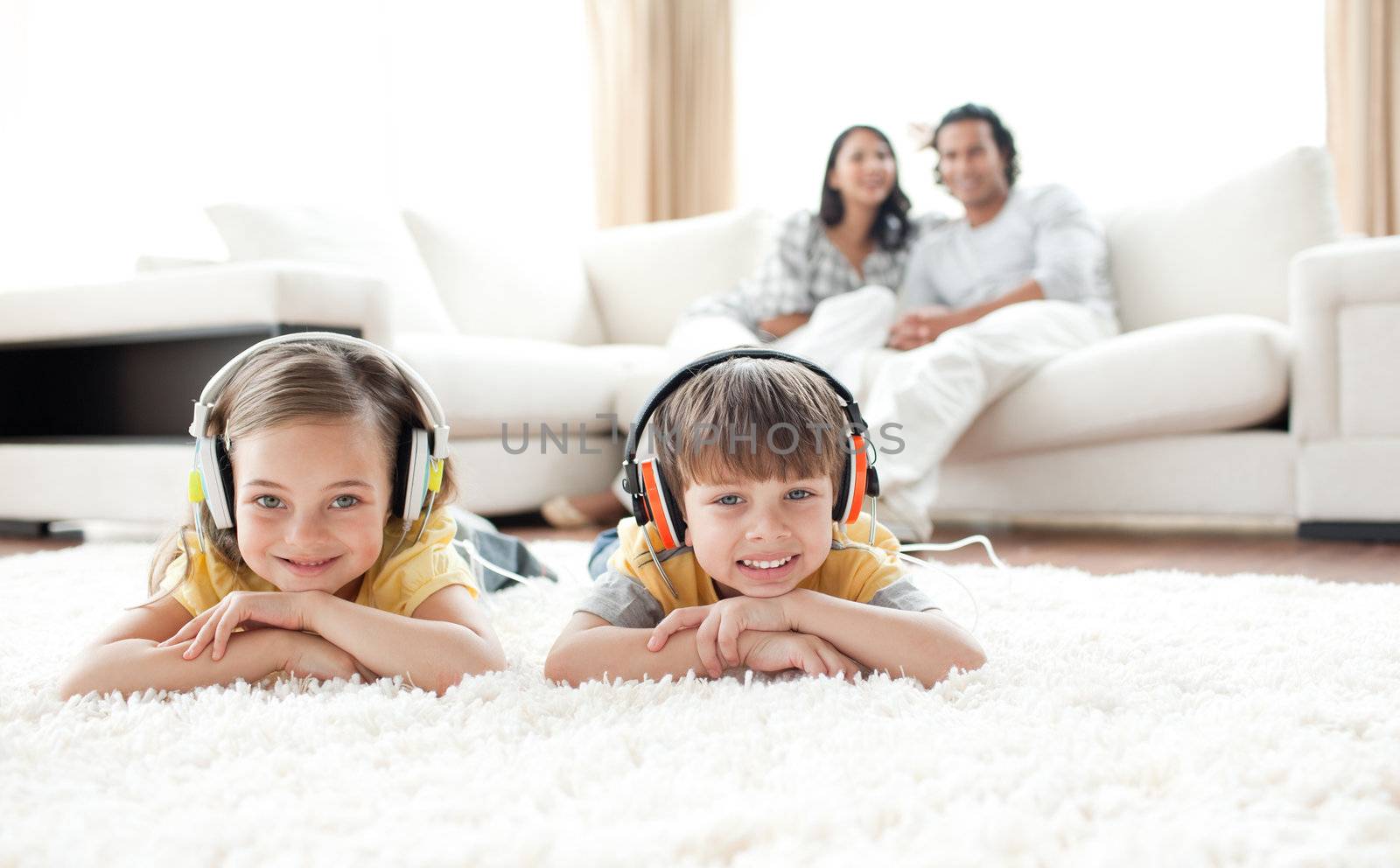 Cute siblings listening music with headphones  by Wavebreakmedia