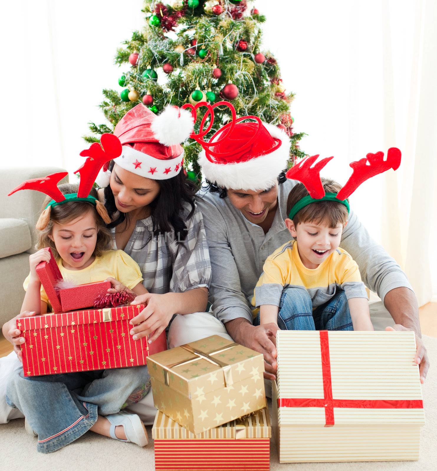 Family decorating a Christmas tree by Wavebreakmedia