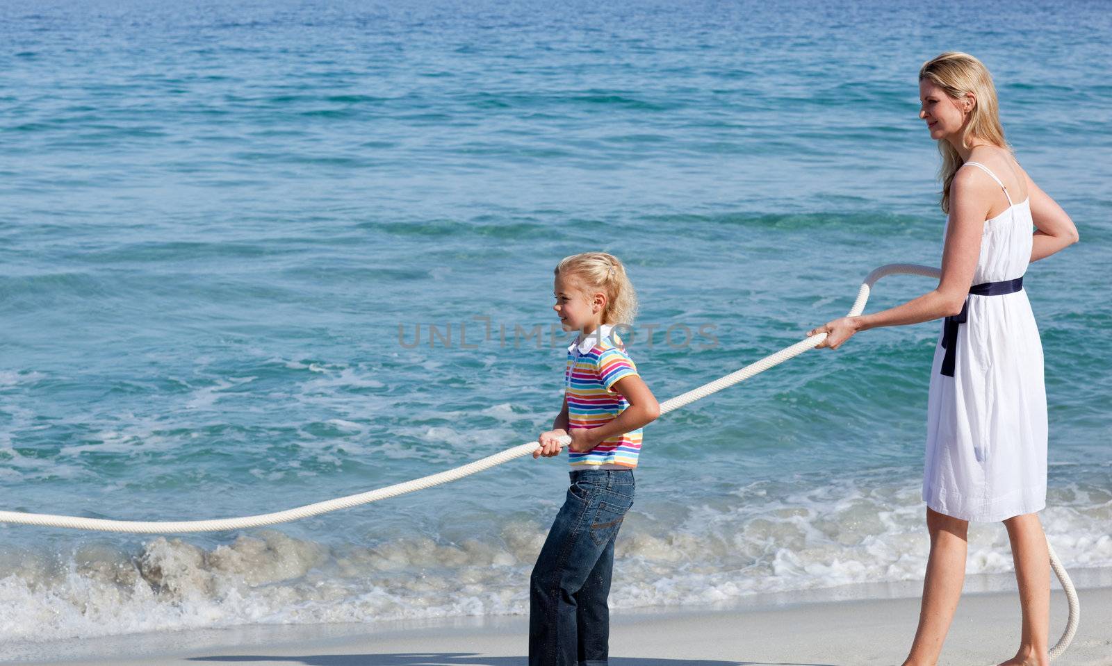 Jolly family playing tug of war  by Wavebreakmedia