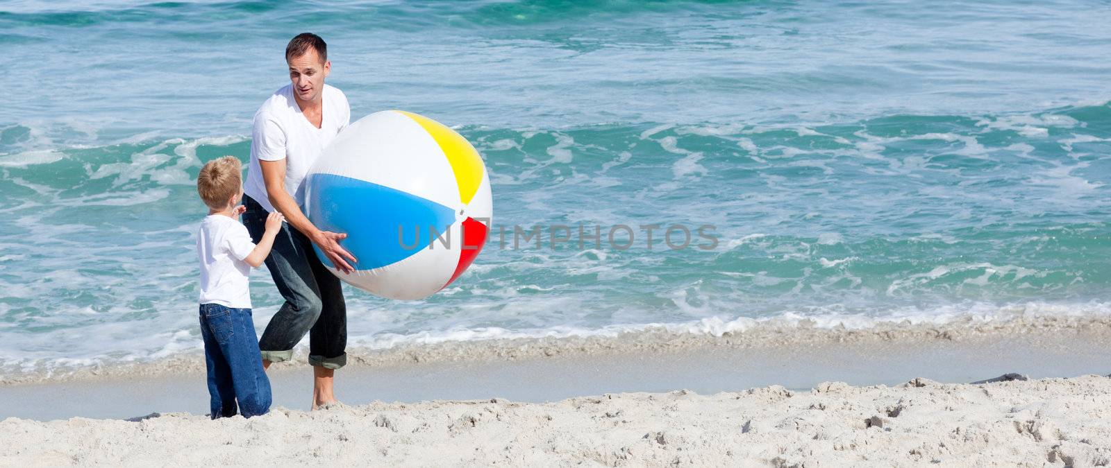 Happy Father and his son having fun at the beach