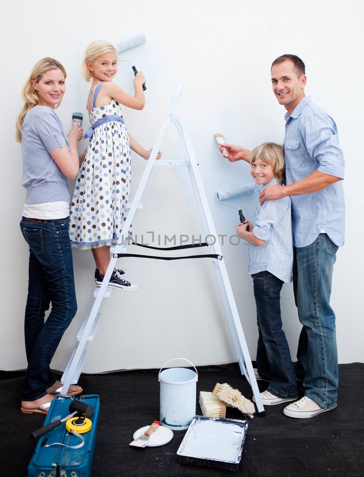 Happy Family decorating their new home together