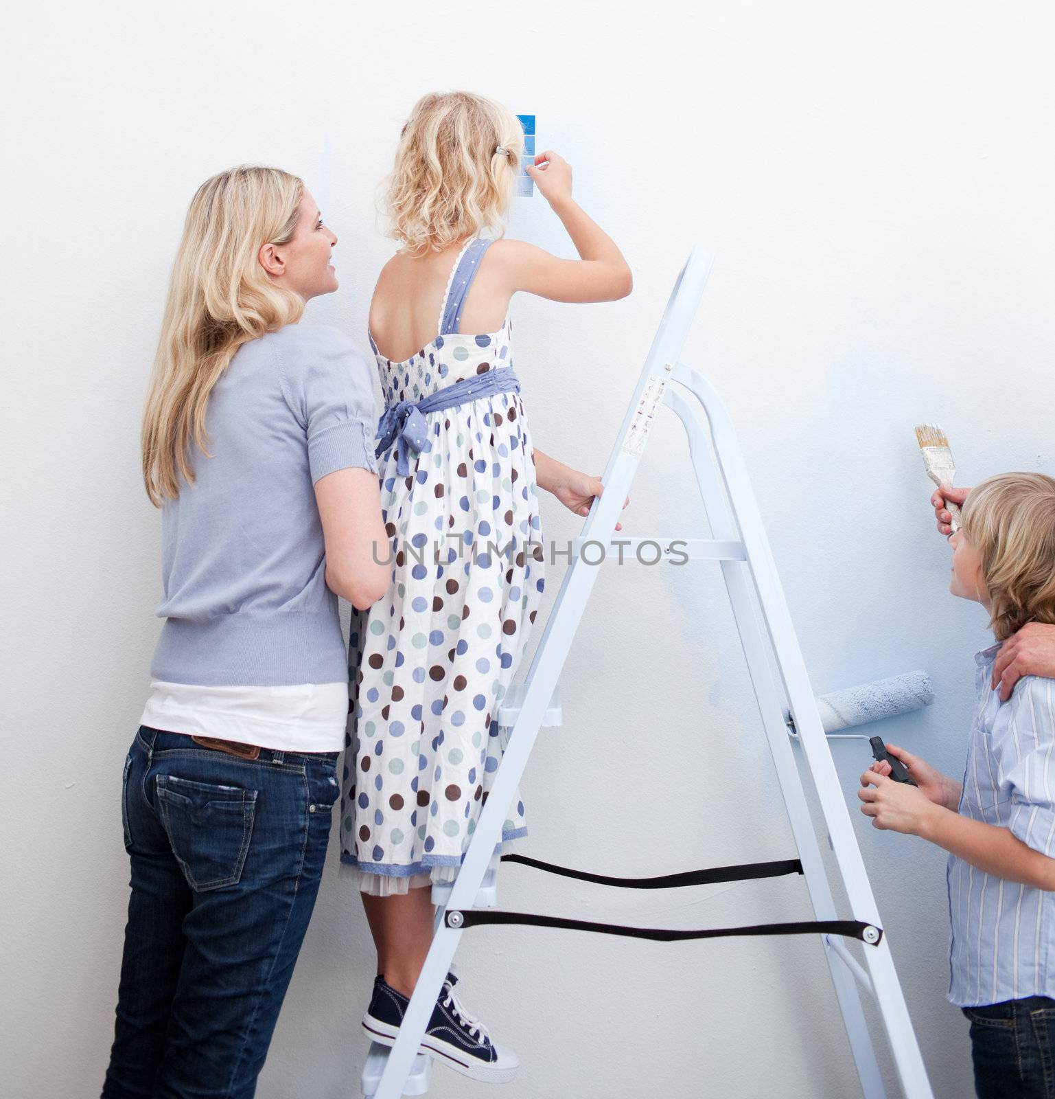 Young family paiting a room  by Wavebreakmedia