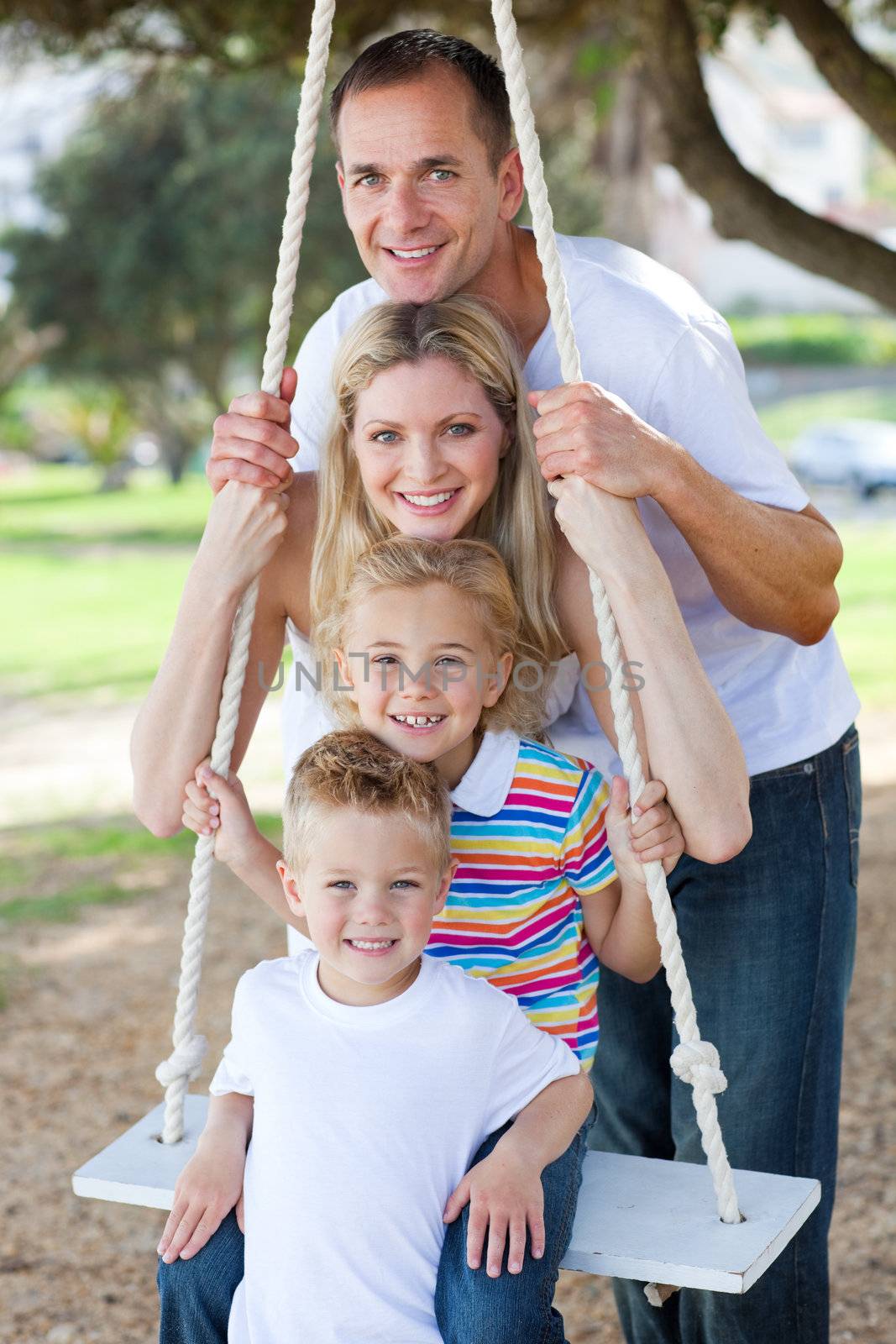  Happy family swinging  by Wavebreakmedia