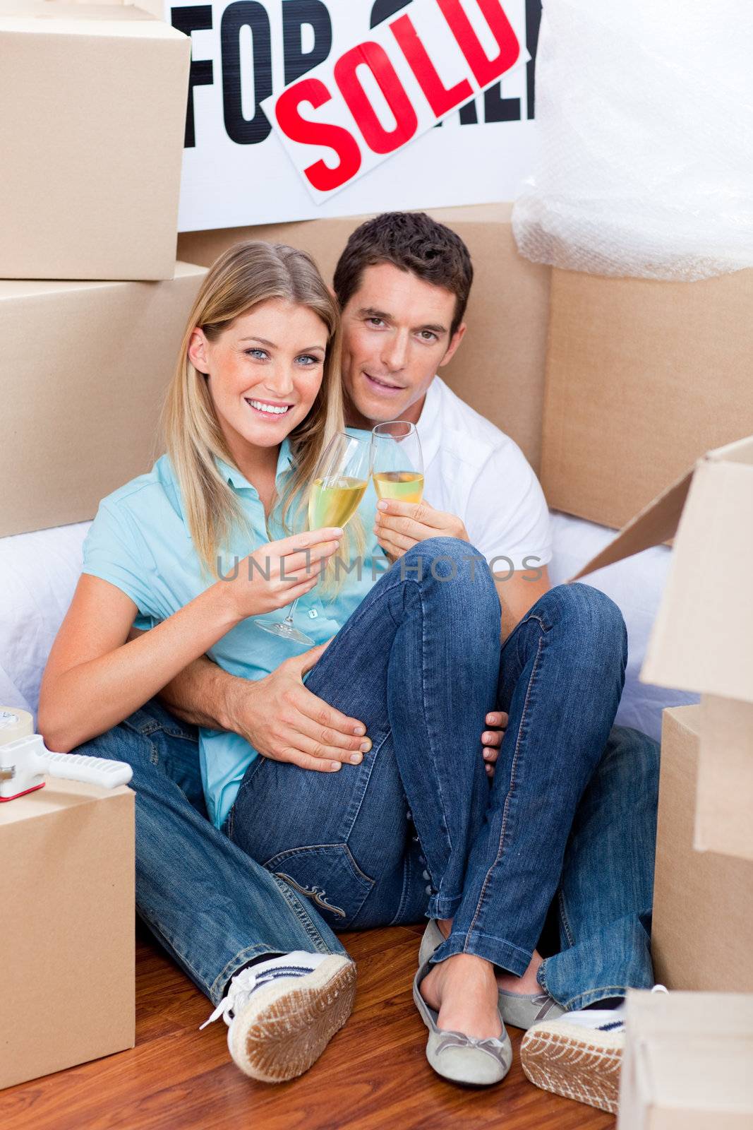 Romantic couple toasting with Champagne after move in