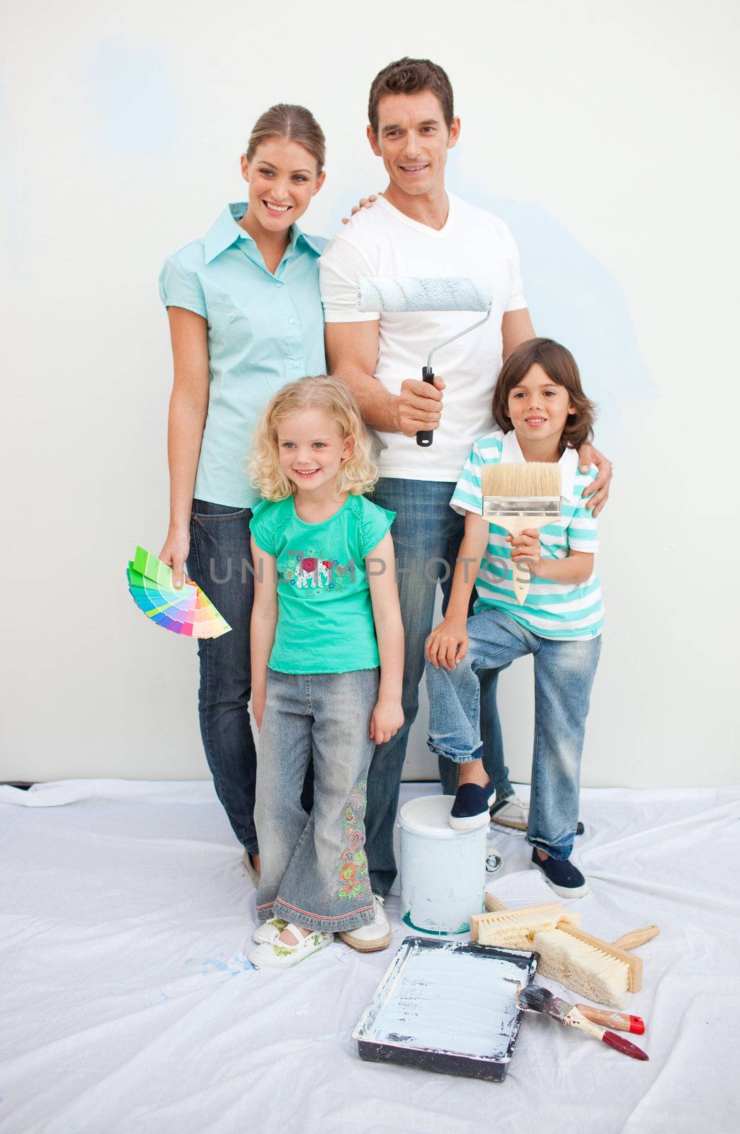 Smiling family decorating their house  by Wavebreakmedia