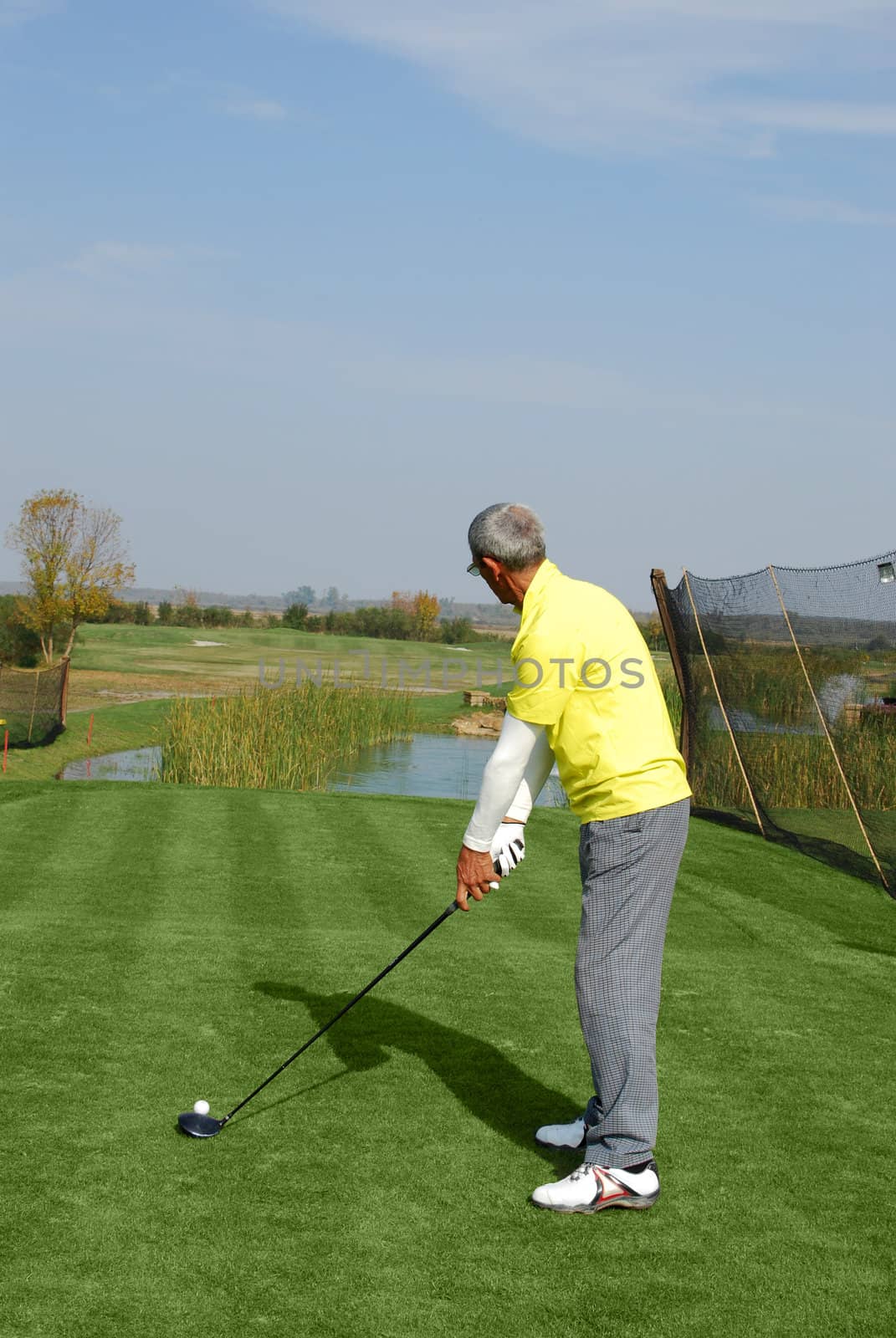 Male golf player ready for hit