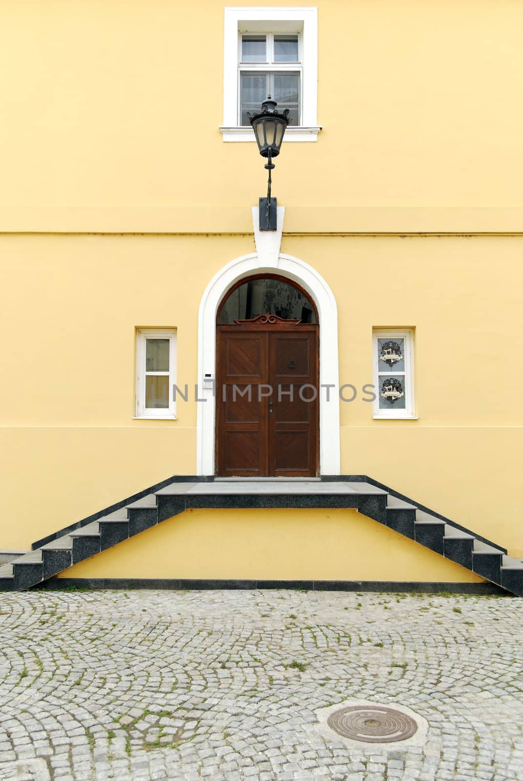 Old yellow house with staircase entrance