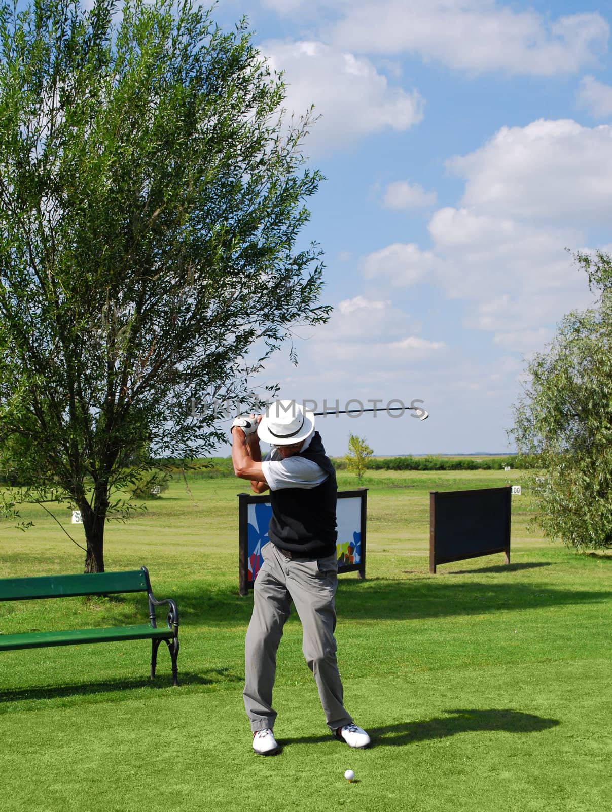 Senior golf player hit ball