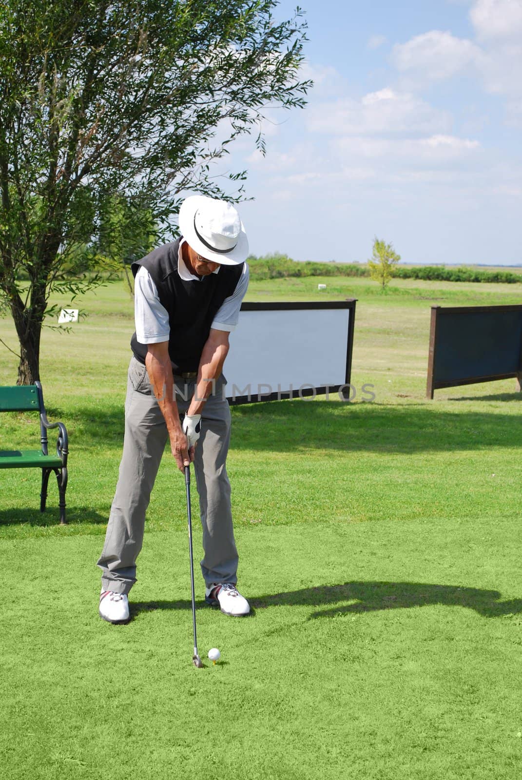 Senior golf player on golf field