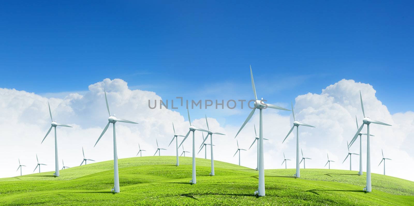 Alternative energy.  Group of energy-producing windmills agains blue sky