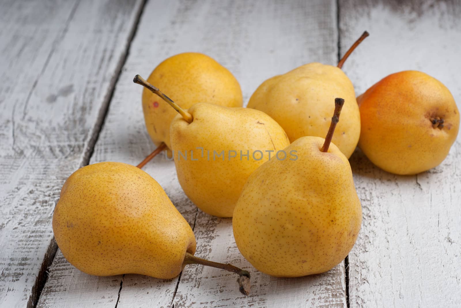 Yellow pears on a wooden table by GennadiyShel
