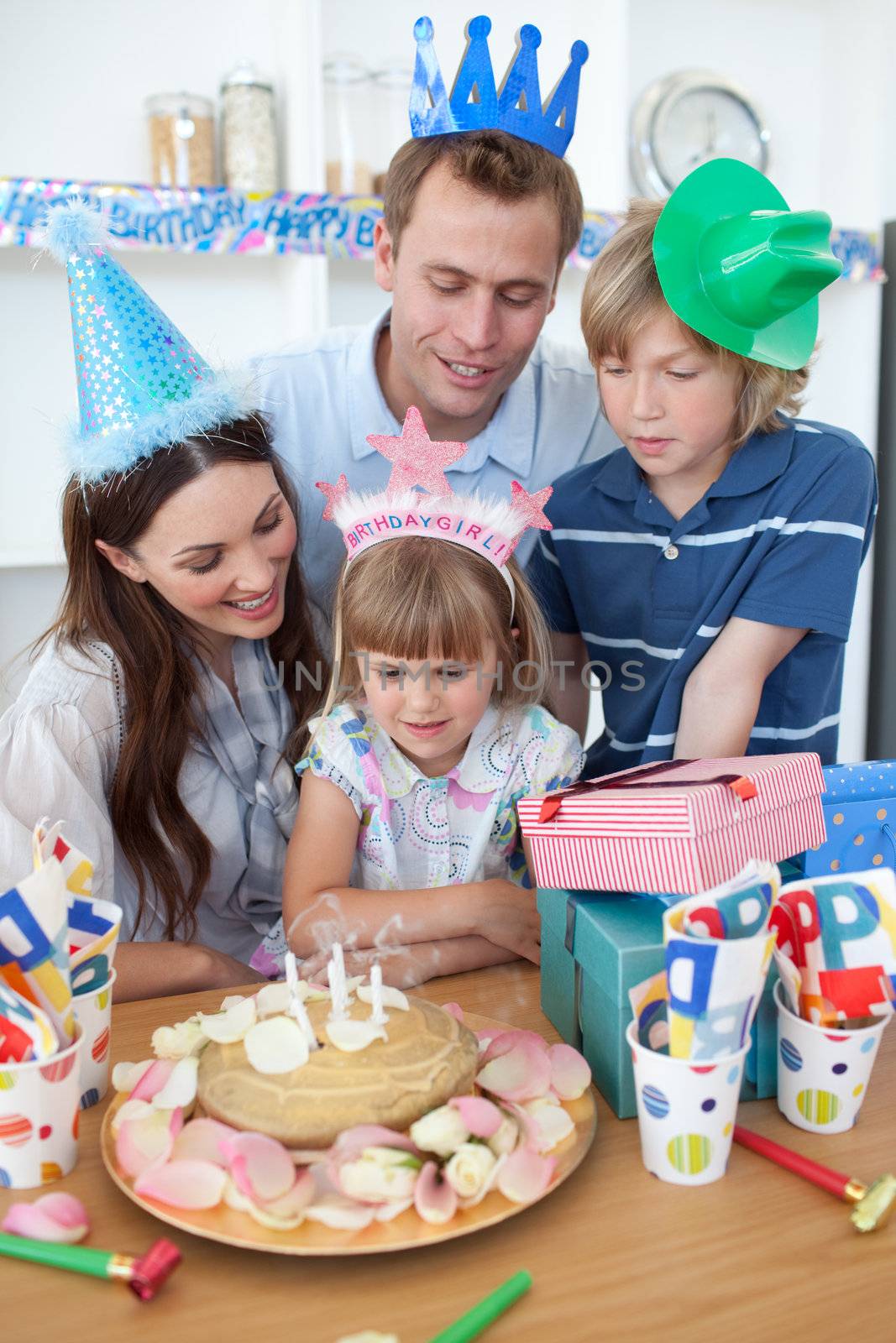 Happy little girl celebrating her birthday in the kitchen