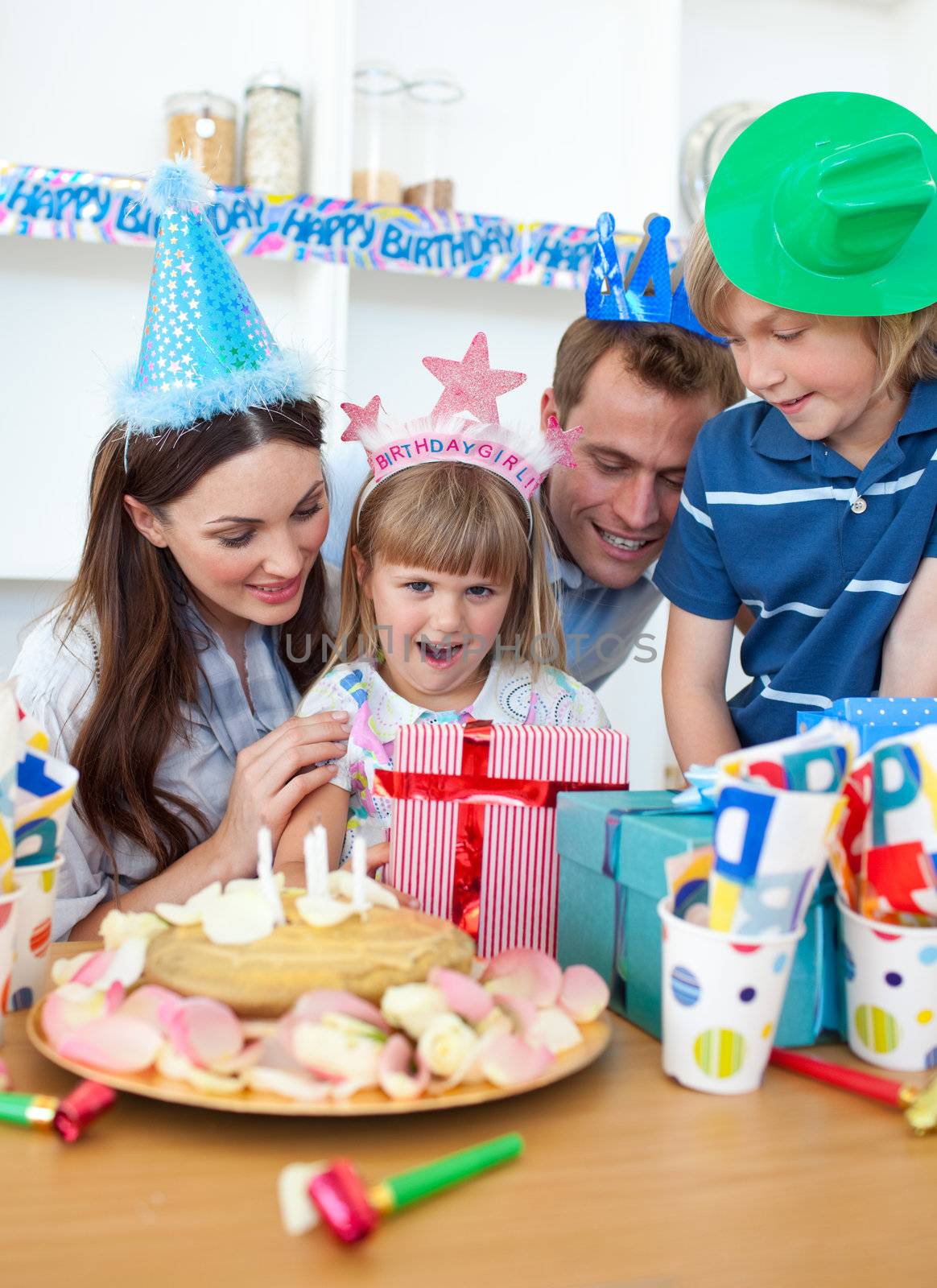 Blond little girl celebrating her birthday in the kitchen