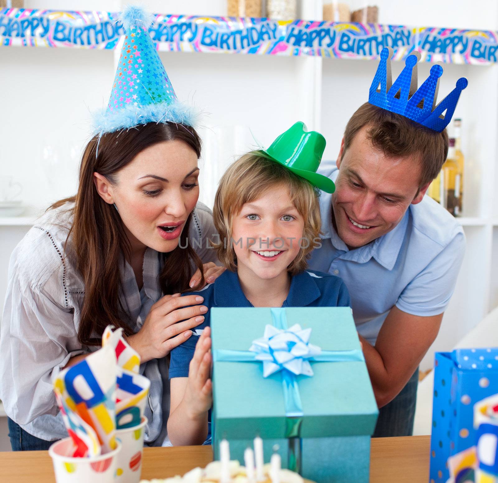 Loving parents celebrating their son's birthday in the kitchen