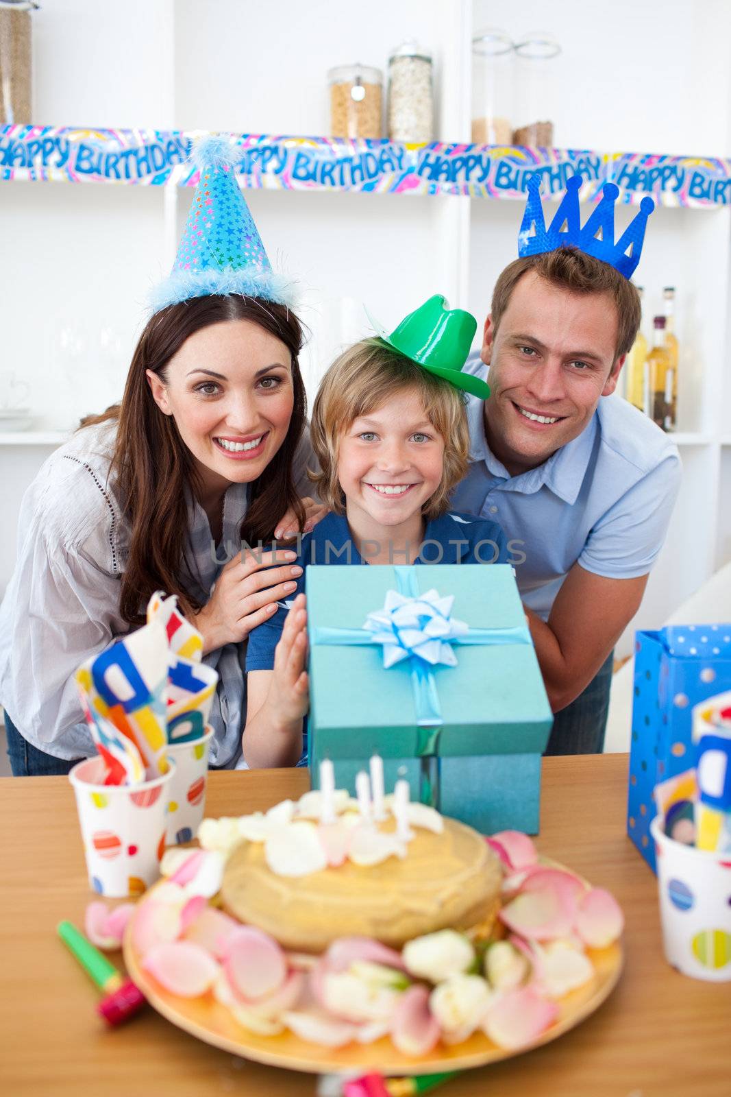 Lively parents celebrating their son's birthday by Wavebreakmedia