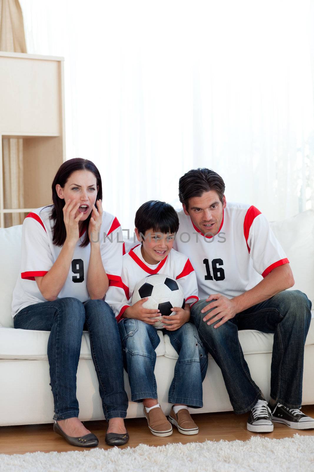 Concentrated family watching football match by Wavebreakmedia