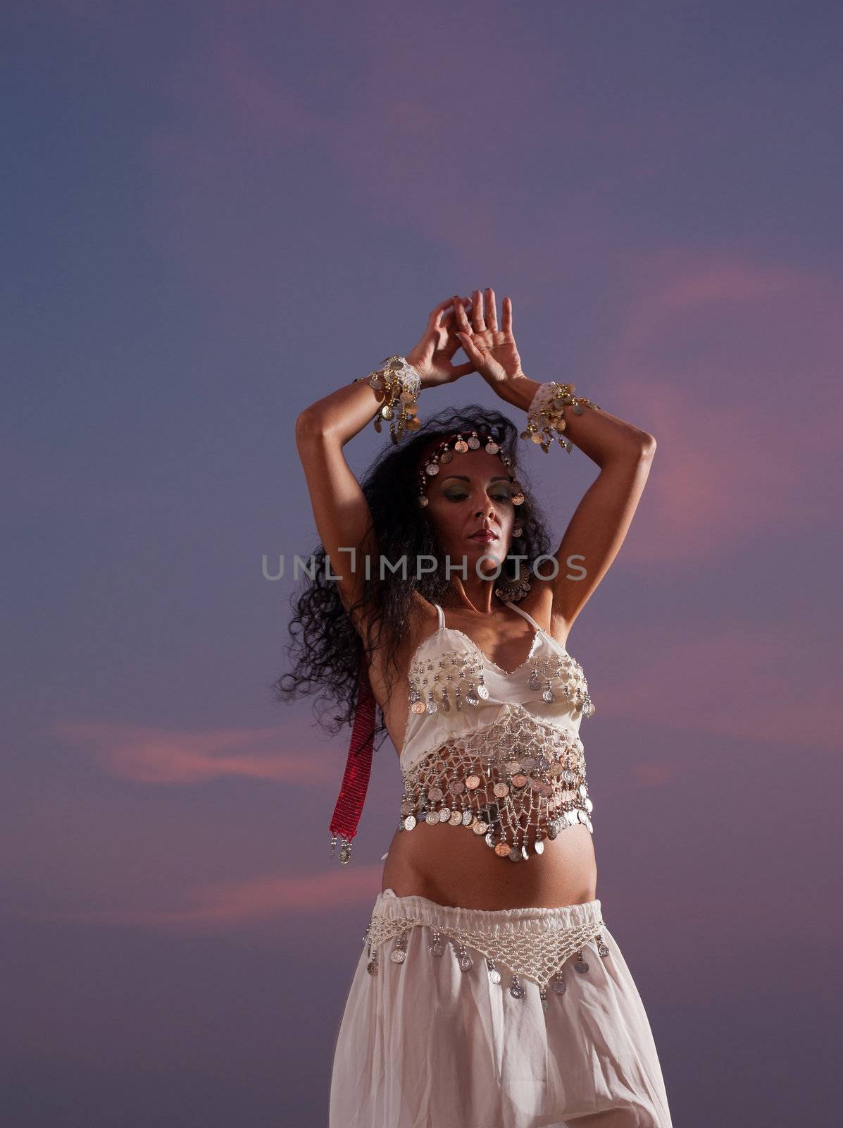 Vertical take of a dancer against an evening sky