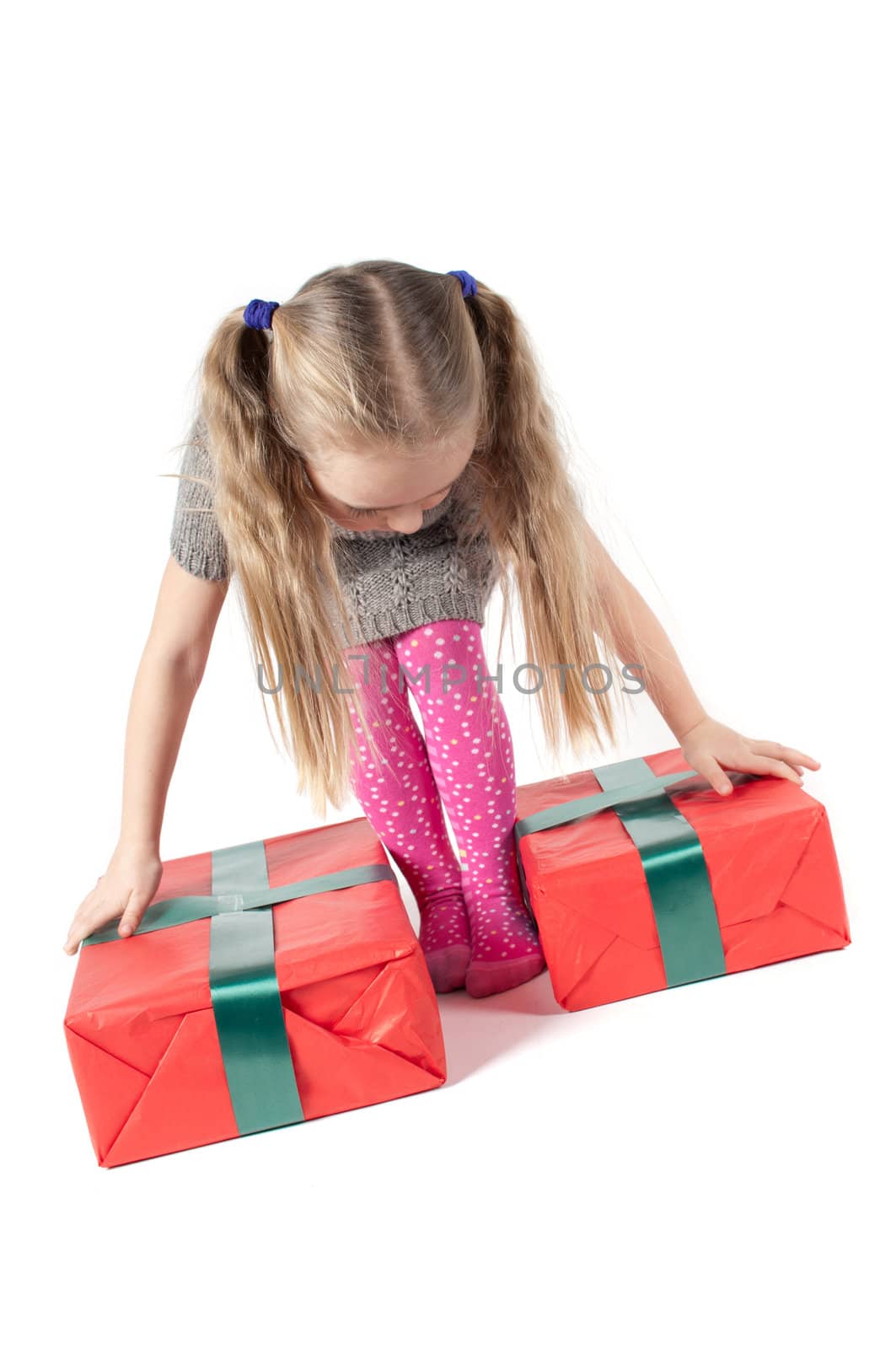 Beautiful girl with christmas presents on white