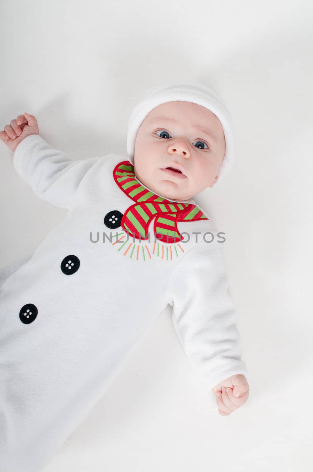 Baby boy in snowman costume on light background