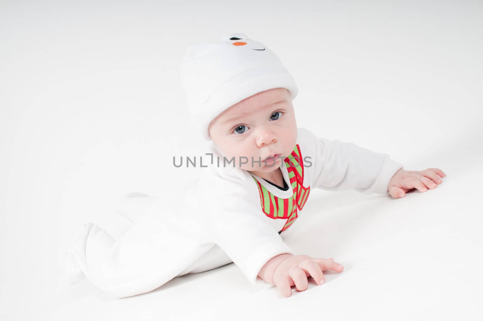 Baby in snowman costume lying on the floor by anytka