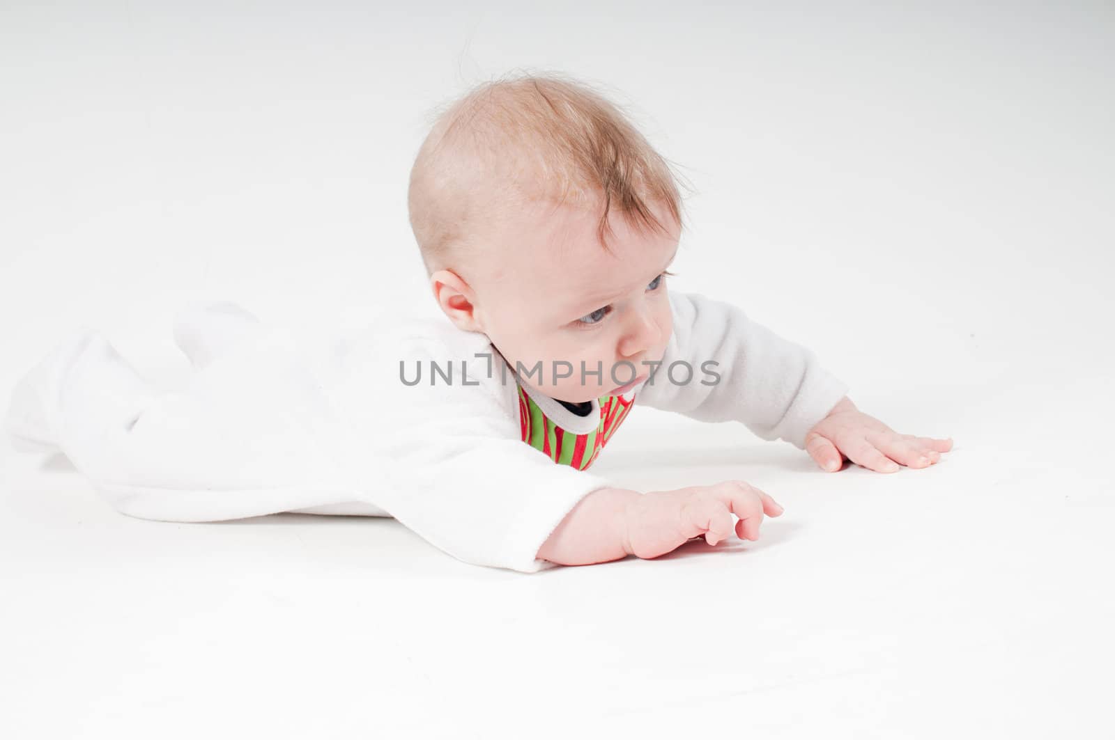 Baby boy in christmas costume on light background